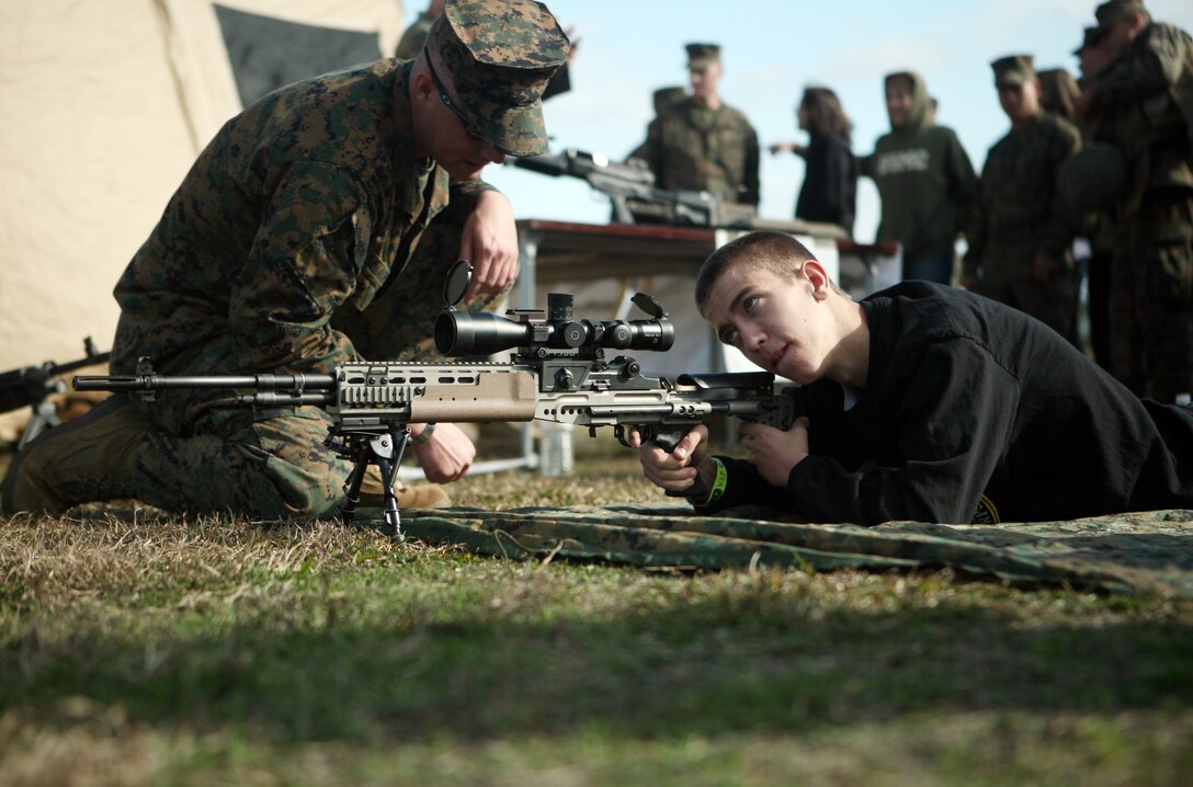 Steven James, an honorary Marine for the day, sites in on a target during Jane Wayne day with Combat Logistics Regiment 27, 2nd Marine Logistics Group, at W.P.T. Hill Field aboard Camp Lejeune, N.C., Dec. 9, 2011. During the day, James, despite heart complications, ran a combat fitness test, fired an M16 A2 service rifle and learned basic Marine Corps Martial Arts Program moves. (U.S. Marine Corps photo by Pfc. Franklin E. Mercado)