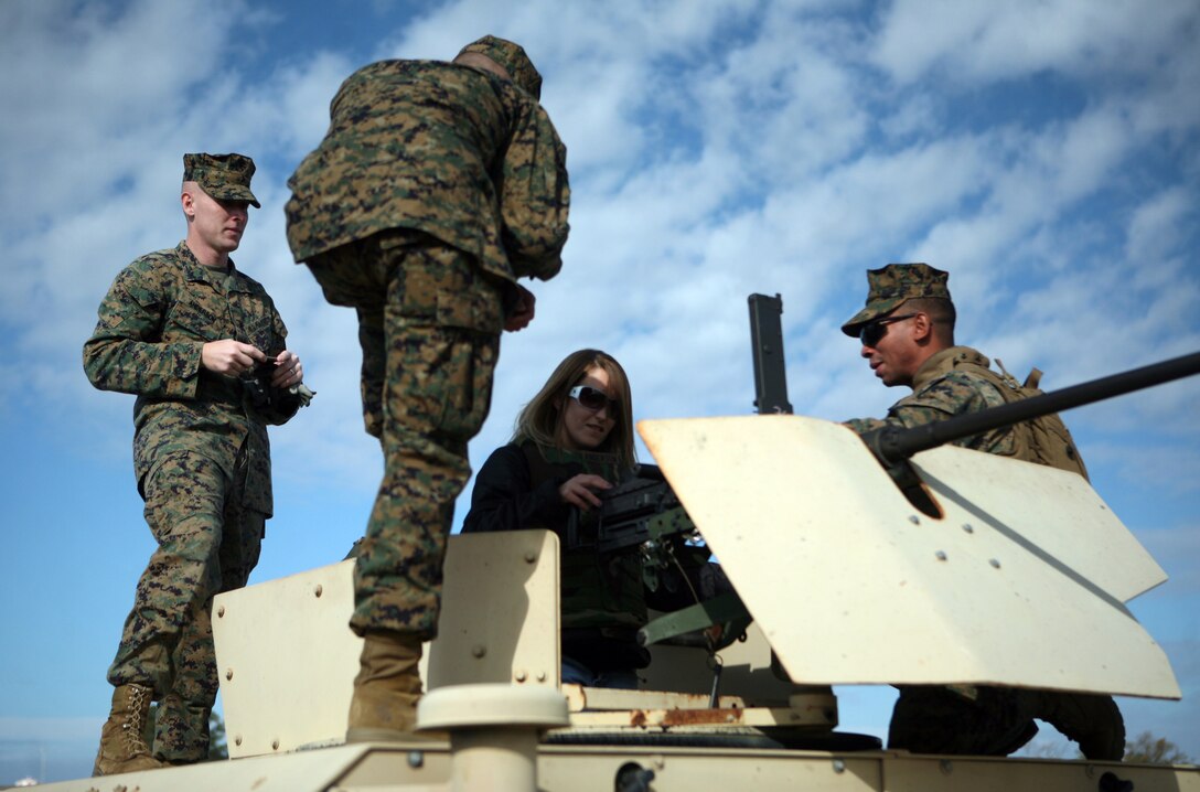 A spouse clears a .50 caliber machine gun during Jane Wayne Day with Combat Logistics Regiment 27, 2nd Marine Logistics Group at W.P.T. Hill Field aboard Camp Lejeune, N.C., Dec. 9, 2011. During the event, spouses participated in a modified combat fitness test, fired rifles and learned basic Marine Corps Martial Arts Program moves. (U.S. Marine Corps photo by. Pfc. Franklin E. Mercado)