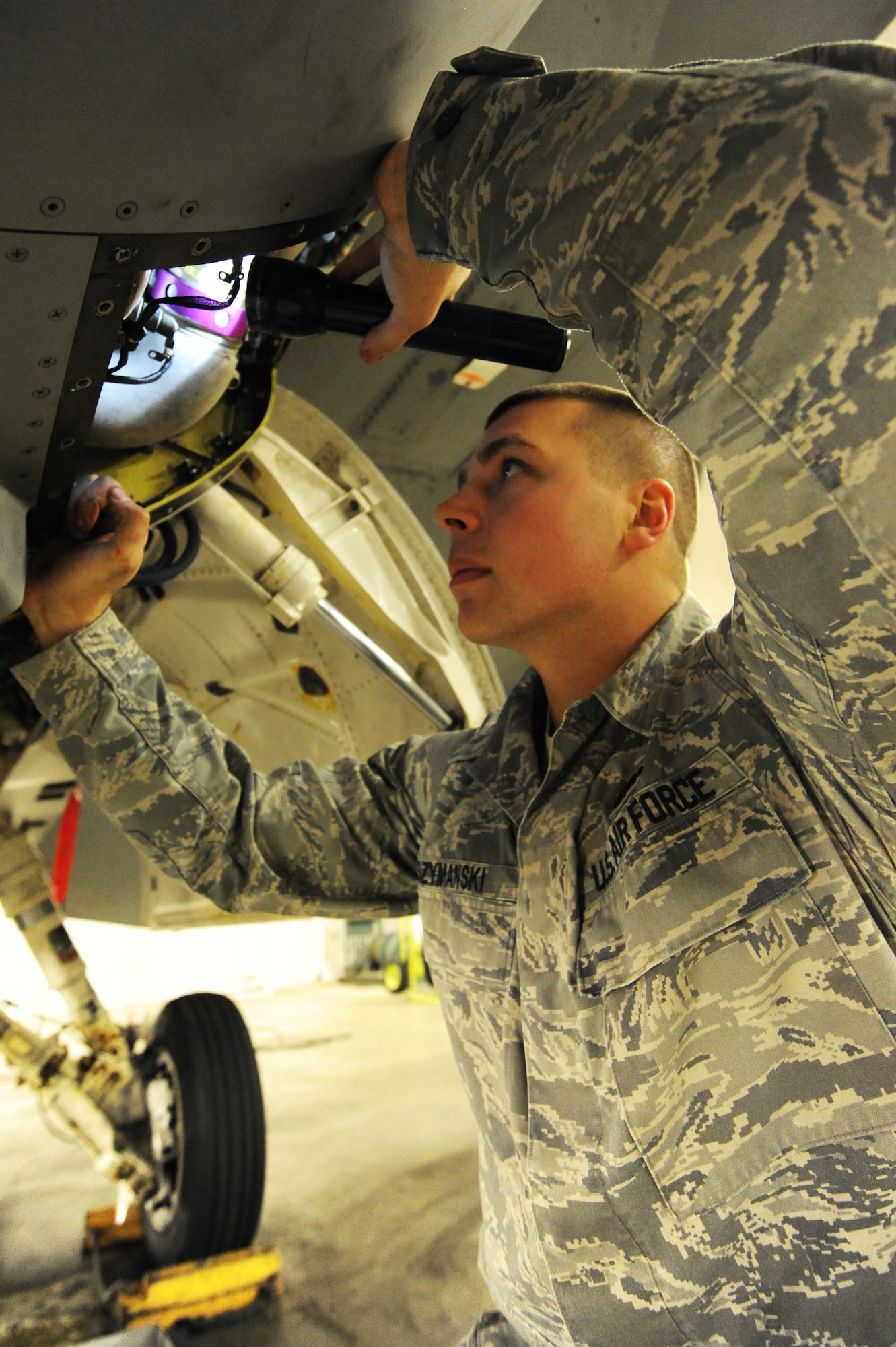 U.S. Air Force Senior Airman Edward Szymanski, 14th Aircraft Maintenance Unit electro-environmental specialist, inspects the environmental control system turbine on an F-16 Fighting Falcon aircraft at Misawa Air Base, Japan, Feb. 15, 2012. The ECS is essential for the proper operation of avionics systems as well as provide a comfortable environment for the pilot to operate in. (U.S. Air Force photo by Airman 1st Class Kia Atkins/Released)