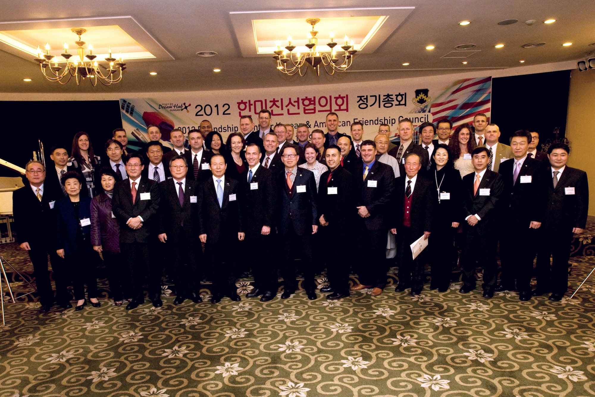 Servicemembers from Kunsan Air Base, Republic of Korea, along with Korean government officials from Gunsan City and local civic leaders pose for a group photo during the Korean and American Friendship Council Annual Friendship Night, Feb. 14, 2012. The event was hosted to show local support and appreciation to the men and women stationed at Kunsan Air Base. (Courtesy photo/Gunsan City Hall)