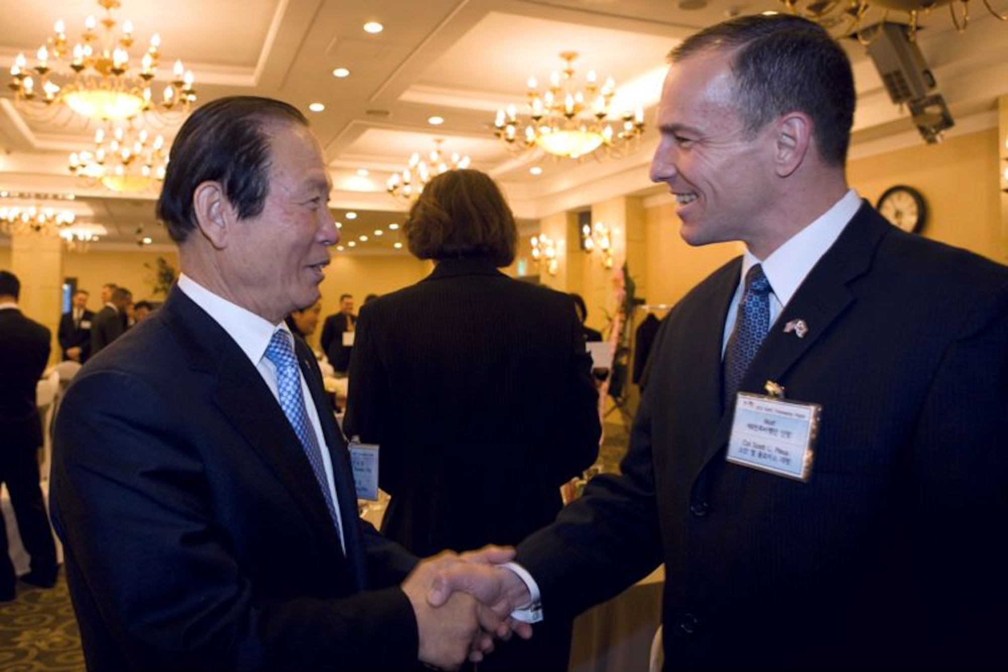 Moon Dong-Shin, mayor of Gunsan, Republic of Korea, and Col. Scott Pleus, 8th Fighter Wing commander, greet each other during the Korean and American Friendship Council Annual Friendship Night, Feb. 14, 2012. The banquet took place at the Rits-Plaza Hotel in Gunsan City, where 60 top Korean government officials from Gunsan City and local civic leaders showed their support and appreciation to the men and women stationed at Kunsan Air Base, ROK. (Courtesy photo/Gunsan City Hall)