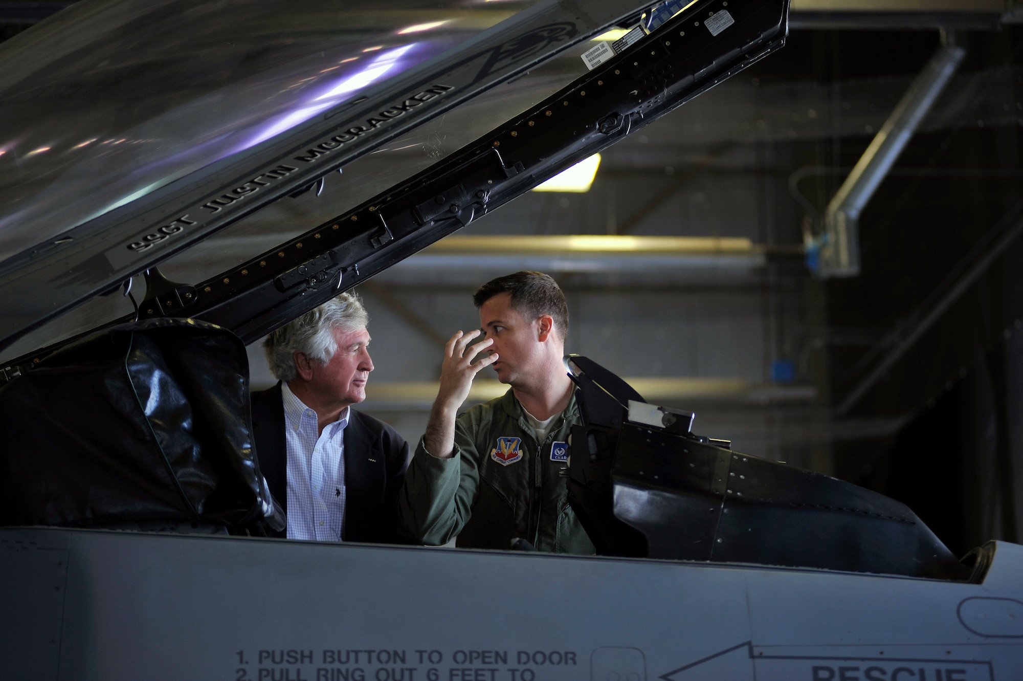 U.S. Air Force Col. Charlie Moore, 20th Fighter Wing commander, (right) discusses the functions of an F-16 Fighting Falcon with his father U.S. Army Col. (ret.) Charles Moore, Sr., Feb. 7, 2012. Moore, Sr. recently visited Shaw to congratulate his son for his recent selection for promotion to the rank of brigadier general. During his visit, he was afforded the opportunity to witness Shaw's mission first hand. (U.S. Air Force photo by Senior Airman Kenny Holston/Released)   


