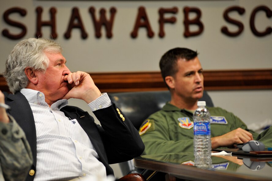 U.S. Army Col. (ret.) Charles Moore, Sr. (left), listens as his son Col. Charlie Moore, 20th Fighter Wing commander, gives a mission briefing, Feb. 7, 2012. Moore, Sr. recently visited Shaw to congratulate his son for his recent selection for promotion to the rank of brigadier general. (U.S. Air Force photo by Senior Airman Kenny Holston/Released)