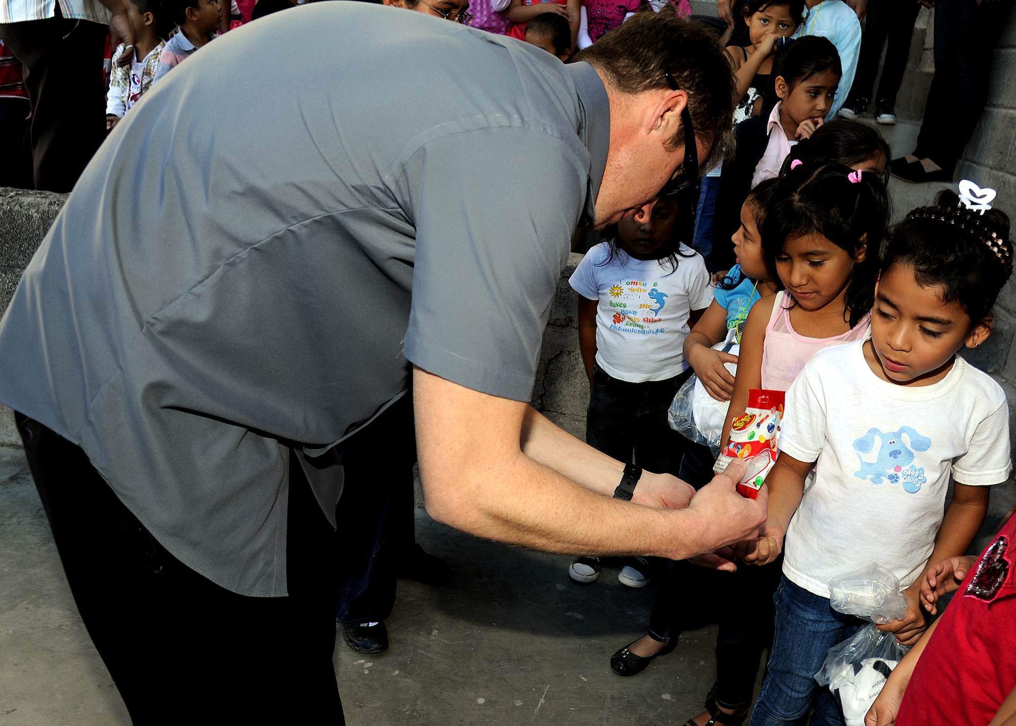 Tech. Sgt. Jeffrey Wright, 763rd Aircraft Maintenance Squadron rotor wing air advisor, Nellis AFB, Nevada, gives students at the Instituto Evangélico El Verbo some jelly beans which were given to the Honduran Air Force as a donation to the school Feb. 17.  Instituto Evangélico El Verbo is sponsored by Stewardship of Christian Ministries, which is a non-governmental Christian organization that promotes the development for some of the less fortunate families in Nueva Suyapa community.  (U.S. Air Force photo by Tech. Sgt. Lesley Waters)