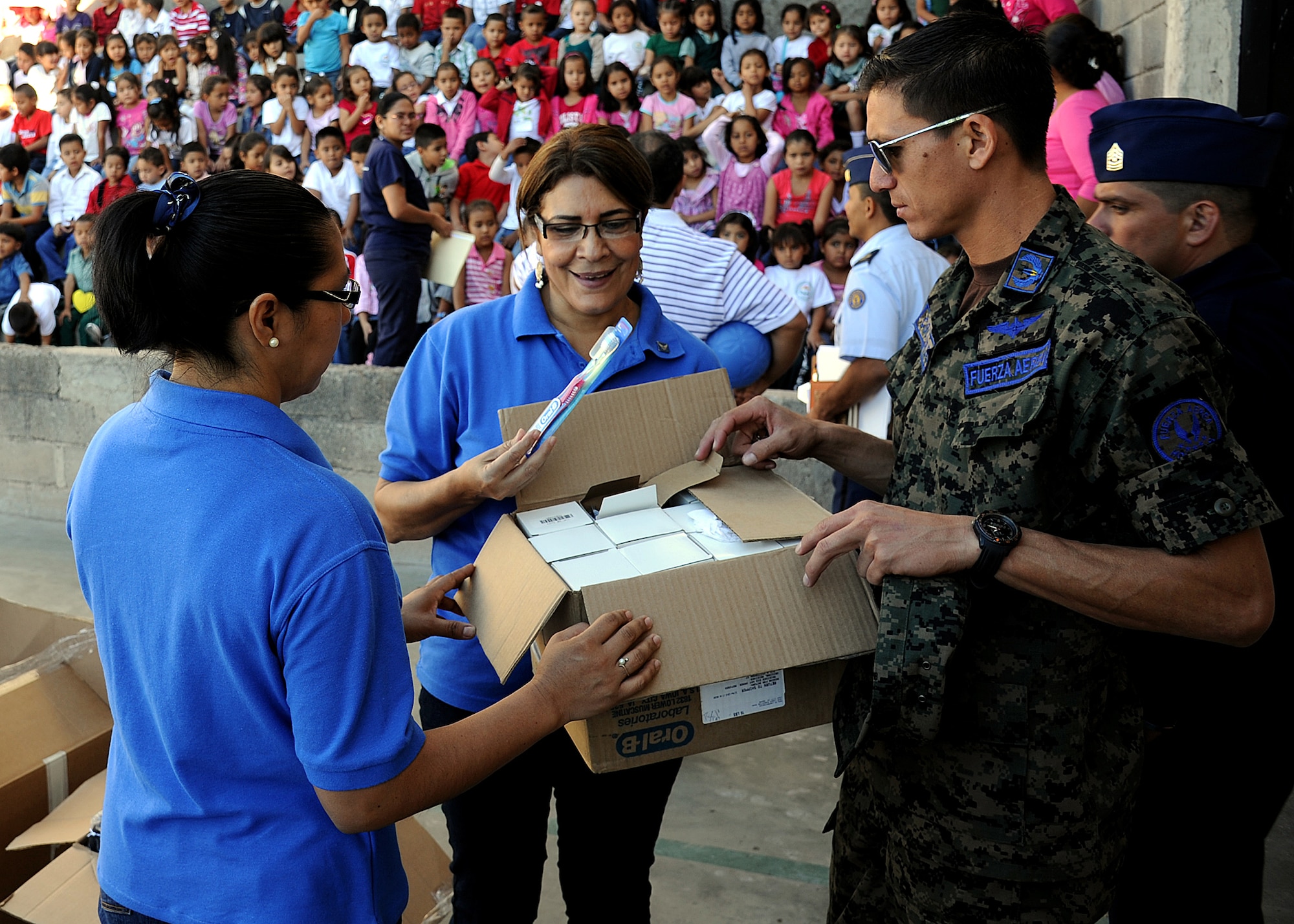 Maritsa Sauceda and Elia Ramona Cruz de Landa, Honduran Air Force officer spouses' society members, look through some of the donated items before distributing them to the students at the Instituto Evangélico El Verbo, in the Nueva Suyapa community of Tegucigalpa, Honduras, Feb. 17.  More than 20 air advisors from the Air Mobility Command's 571st Mobility Support Advisory Squadron and Airmen from the Honduran Air Force extended their building partner capacity mission to the community by visiting two Honduran schools Feb. 14 and 17.  (U.S. Air Force photo by Tech. Sgt. Lesley Waters)