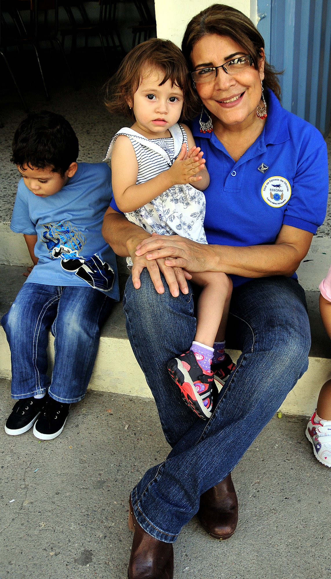Elia Ramona Cruz de Landa, Honduran Air Force officer spouses’ society president, holds a little girl during the visit of the U.S. and Honduran Air Force Airmen to the Instituto El Cordero, in Tegucigalpa, Honduras, Feb. 14.  (U.S. Air Force photo by Tech. Sgt. Lesley Waters)