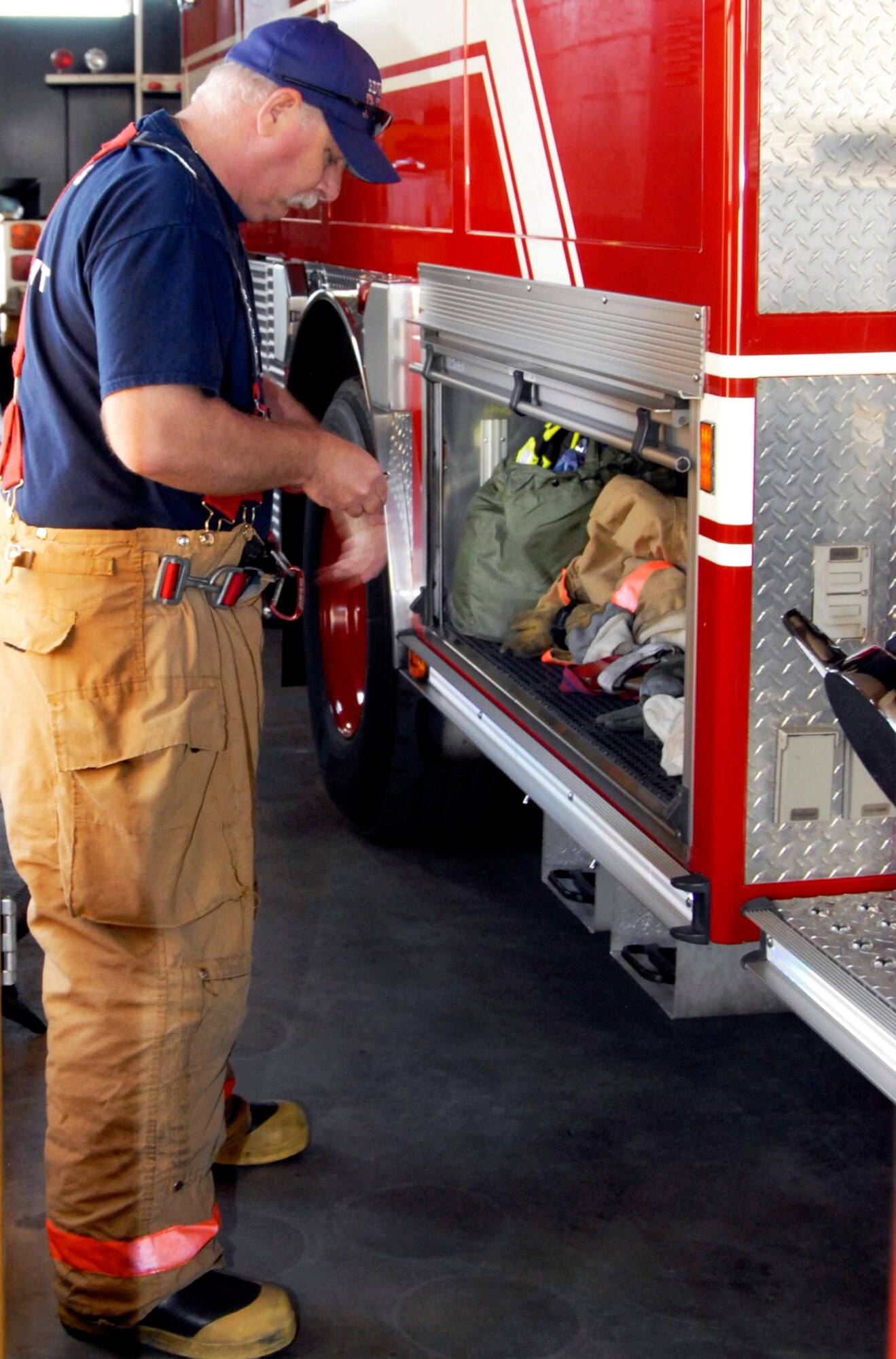Rex Bair quickly dresses in his protective gear in response to an emergency on Feb. 17. In less than 60 seconds Bair and his crew were dressed and enroute. The Edwards AFB Fire Department receives more than 1,200 emergency response calls every year. (U.S. Air Force Photo by Laura Mowry)