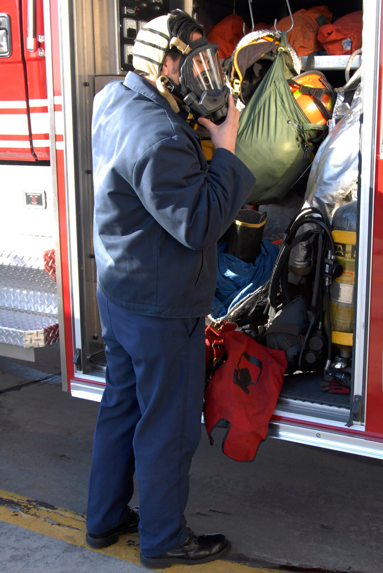 Fireman Matthew Dennison inspects the equipment aboard Fire Station 1's rescue vehicle.  Each morning, the Edwards firefighters inspect all equipment and vehicles to ensure proper working order during an emergency. (U.S. Air Force Photo by Laura Mowry)