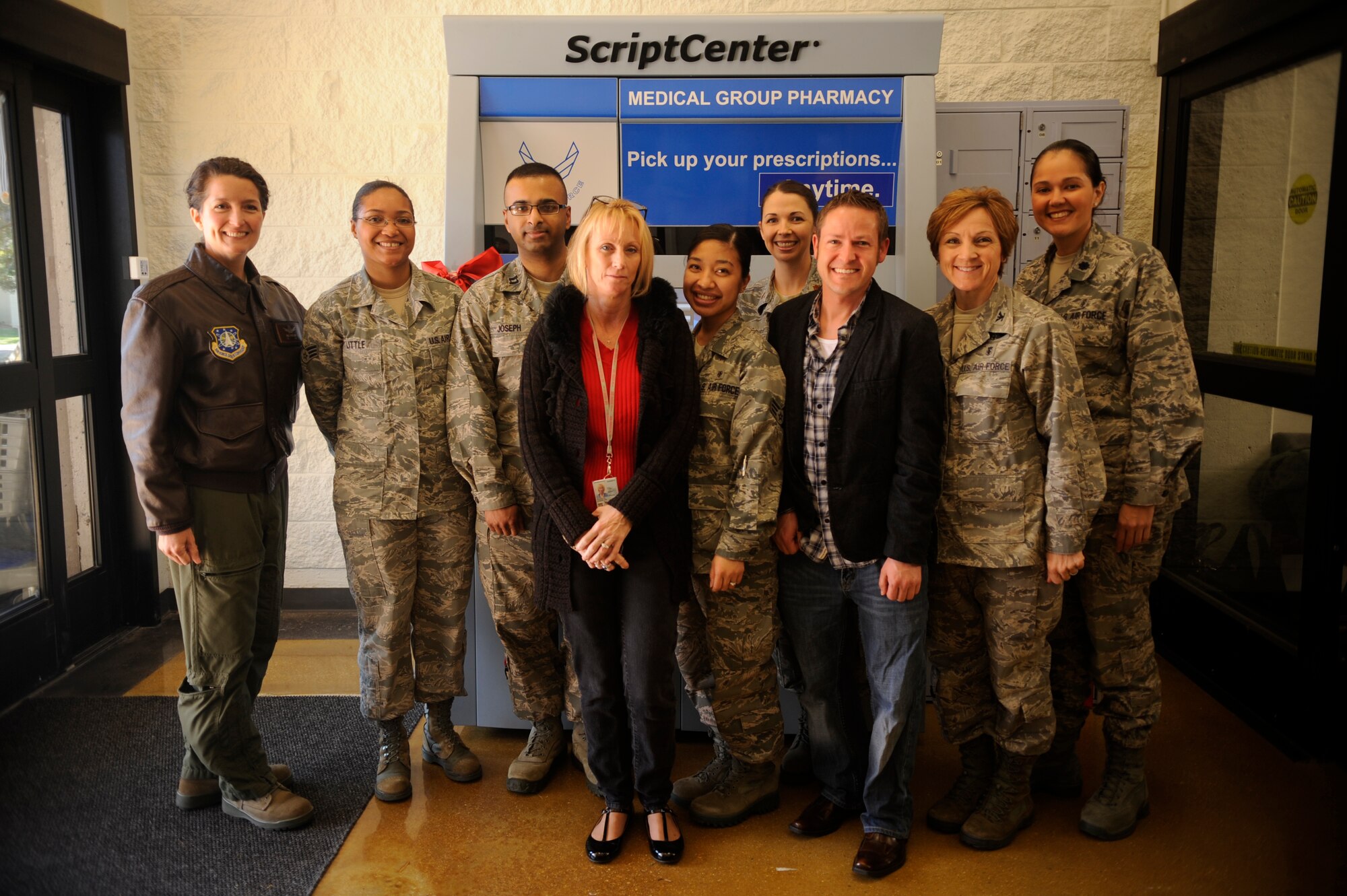 VANDENBERG AIR FORCE BASE, Calif. -- Col. Nina Armagno, 30th Space Wing commander, and 30th Medical Group personnel pose for a group photo in front of a Script Center kiosk at the base exchange here Feb. 17, 2012. The kiosk is accessible for customers seven days a week, which helped increase pharmacy availability by 35 hours. (U.S. Air Force photo/Staff Sgt. Andrew Satran) 

 