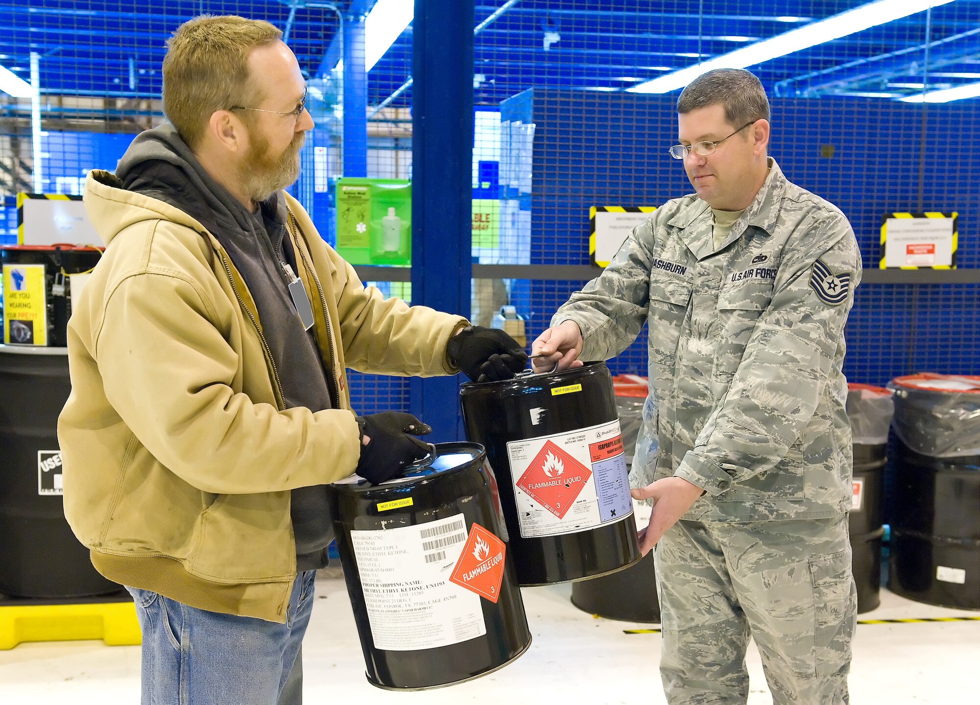 Deral Freysinger, Hazardous Waste Manager, with the 436th Civil Engineering Squadron, and Michael Shehorn, a contractor with Northwind Engineering, collect hazardous waste at building 711 maintenance hangar's Hazardous Waste 90-Day Accumulation Point, February 16, 2012, Dover Air Force Base, Delaware. Freysinger and Shehorn collected various types of hazardous waste, transported them to building 1306, separated, prepared and stored them for recycling. Tech. Sgt. Neil Mashburn, NCO in charge of the Maintenance Steering Group 3 Consolidated Tool Kit section, 436th Maintenance Squadron, prepared hazardous waste items for pick up. (U.S. Air Force photo by Roland Balik)