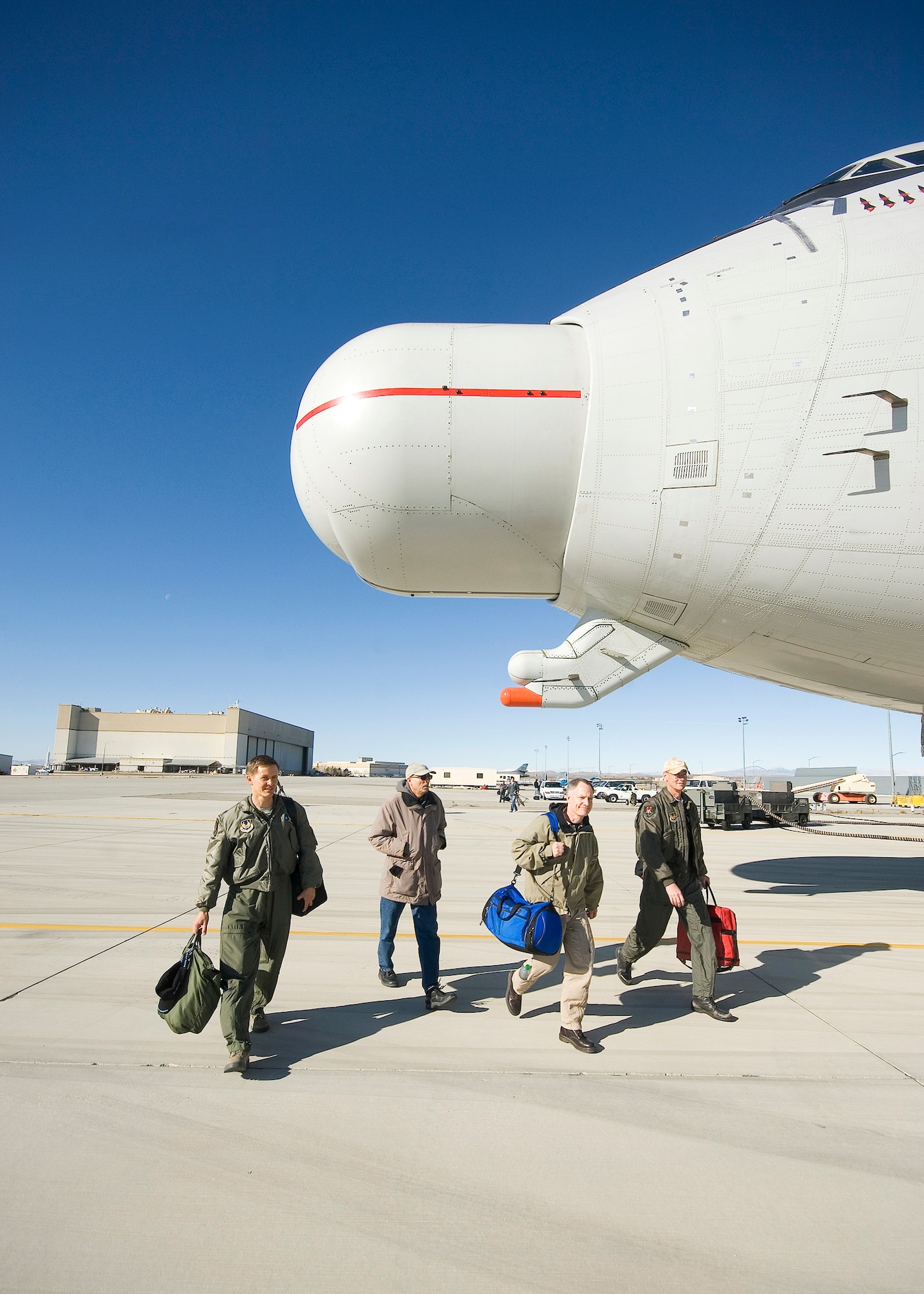 (From left to right) Lt. Col. Jeff Warmka, Airborne Laser Test Bed Combined Test Force director, Doug Canning, ALTB CTF test conductor, Barry St. Germain, Boeing pilot, and Roc White, ALTB CTF test conductor, step to the ALTB aircraft Feb. 14 before starting engines for its final flight at Edwards Air Force Base, Calif. (U.S. Air Force photo by Rob Densmore)
