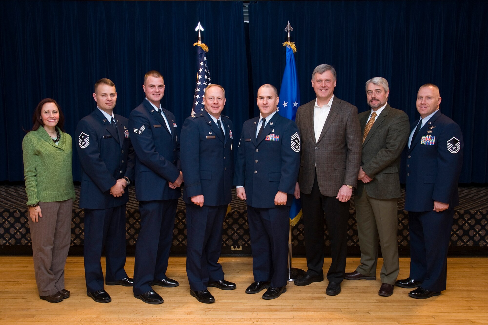 PETERSON AIR FORCE BASE, Colo. - The Team Pete Annual Awards were announced Feb. 17 at The Club. The winners include (left to right): Sarah Casebolt, 21st Medical Group, civilian non-supervisory category one of the year; Master Sgt. Galen Zalace, 21st Mission Support Group, first sergeant of the year; Senior Airman Nicholas Hurt, 721st Mission Support Group, junior enlisted of the year; Col. Chris Crawford, 21st Space Wing commander; Chief Master Sgt. Thomas R. Trottier, 21st SW command chief master sergeant; Norm Churchill, Space and Missile Systems Center, civilian supervisory category two of the year; David Salisbury, Headquarters Air Force Space Command, civilian non-supervisory category two of the year; and Master Sgt. David Carr, 21st Operations Group, senior noncommissioned officer of the year. Not pictured are Captain Aaron Cleveland, 13th Air Support Operations Squadron, company grade officer of the year; and Tech. Sgt. Nathan Bluto, 21st MDG, noncommissioned officer of the year. (U.S. Air Force photo/Craig Denton)