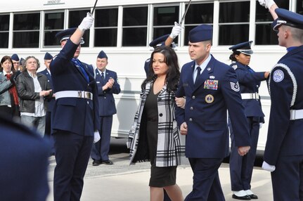 Tech. Sgt. Victor Follis, 364th Recruiting Squadron recruiter, and his wife, Jillian, arrive at Headquarters Air Force Recruiting Service during an Operation Blue Suit ceremony here Feb. 8. Each year Operation Blue Suit recognizes top Air Force recruiters worldwide. Winners are nominated by their recruiting groups and selected based on their performance in meeting assigned recruiting goals, leadership qualities and other professional traits. This year 15 members of AFRS were recognized as tops in their field. (U.S. Air Force photo/Christa D’Andrea)
