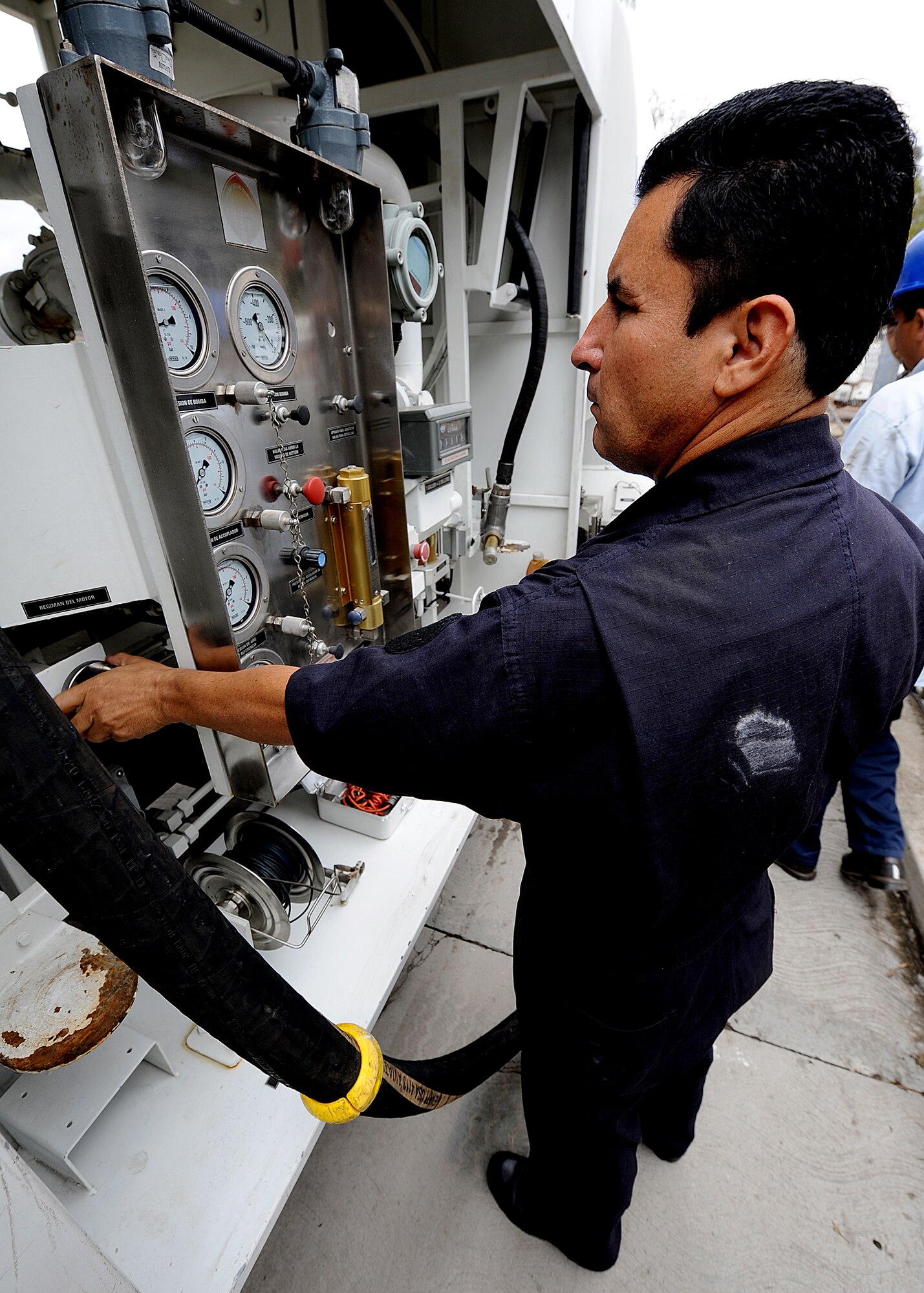 A Honduran contractor adjusts the RPMs needed for recirculation of fuel on the refueling vehicle before fuel sample could be taken, in Tegucigalpa, Honduras, Feb. 13.  The MSAS Airmen, representing 15 Air Force specialties, is working side-by-side with Honduran Air Force members in developing the seven core competencies of air base defense, air traffic control, aircraft maintenance, aircrew survival, communications, generator maintenance and safety.   (U.S. Air Force photo by Tech. Sgt. Lesley Waters)
