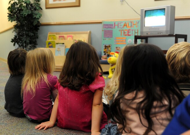 Children watch a video on the importance of brushing their teeth at the Child Development Center at Joint Base Charleston - Air Base Feb. 10. Every Februrary, the American Dental Association sponsors National Children's Dental Health Month to raise awareness of the importance of children's oral health. (U.S. Air Force photo / Airman 1st Class Ashlee Galloway)
