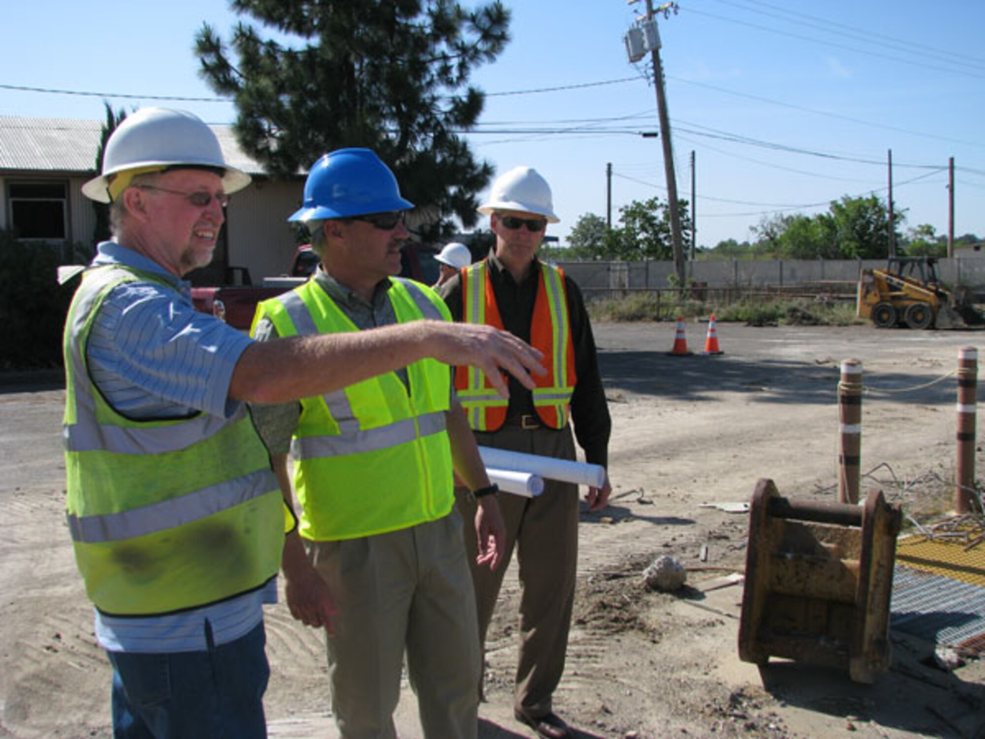 Engineer Paul Bernheisel, left, discusses field work at the former McClellan AFB with colleagues.