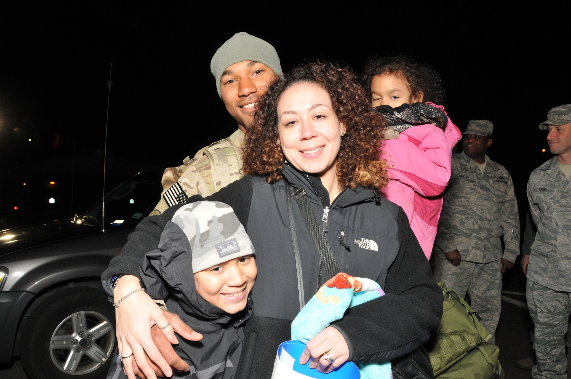 It’s all smiles as Staff Sgt. Kevin Davis stands with his wife, Senior Airman Rashonne Davis and their children, Sean, 10 and Kloe, 7, upon his return to Bradley Air National Guard Base in East Granby, Conn. from Afghanistan Feb. 20, 2012. Davis is assigned to the 103rd Civil Engineer Squadron and had been deployed since July 2011 with the Expeditionary Prime Base Engineer Emergency Force (BEEF) squadron, performing light construction and facility repair operations including plumbing, interior electric, HVAC, power production and distribution, as well as other engineering tasks.. (U.S. Air Force photos by Tech. Sgt. Erin McNamara\RELEASED)