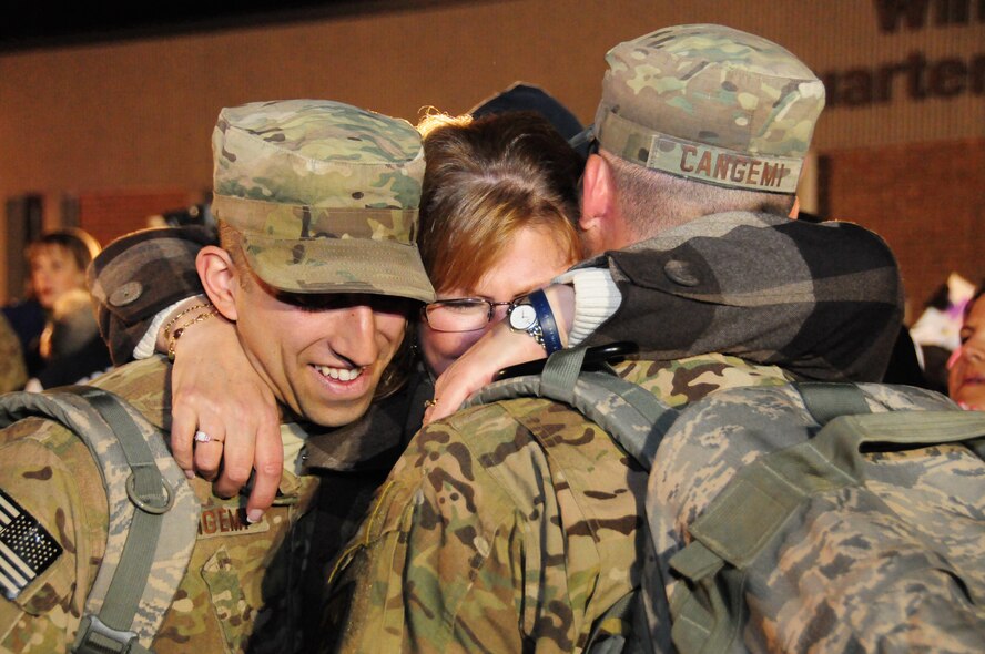 Mary Blodgett (center) embraces her sons Nick (right) and Chris (left) upon their return to Bradley Air National Guard Base in East Granby, Conn. from Afghanistan Feb. 20, 2012. The brothers are both Senior Airmen assigned to the 103rd Civil Engineer Squadron and had been deployed since July 2011 with the Expeditionary Prime Base Engineer Emergency Force (BEEF) squadron, performing light construction and facility repair operations including plumbing, interior electric, HVAC, power production and distribution, as well as other engineering tasks.. (U.S. Air Force photos by Tech. Sgt. Erin McNamara\RELEASED)