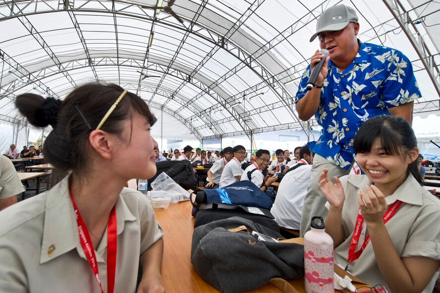 CHANGI, Singapore -- U.S. Air Force Tech. Sgt. Richard Vasquez, U.S. Air Force Band of the Pacific, Hawaii sings to a Singaporean girl in the audience during a performance on Feb. 17, 2012, at the 2012 Singapore Airshow. The band provided entertainment during the week long Singapore trade and air show performing 13 times. (Department of Defense photo by U.S. Air Force Tech. Sgt. Michael R. Holzworth/Released)