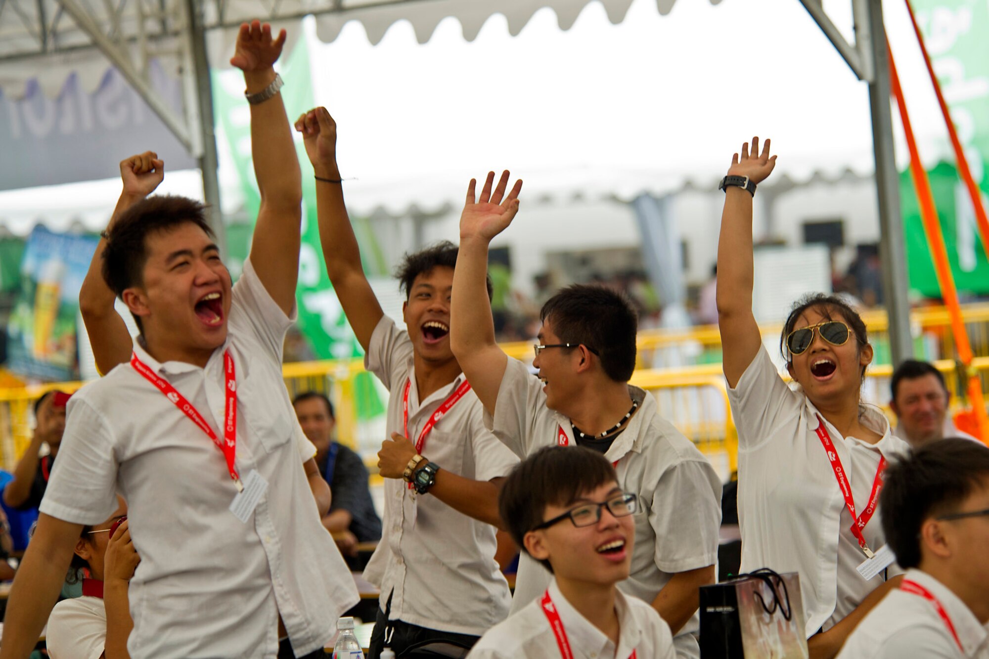 CHANGI, Singapore -- Aerospace and Avionics students from the Institute of Technical Education cheer and dance as the U.S. Air Force Band of the Pacific, Hawaii performs Feb. 17, 2012, at the 2012 Singapore Airshow. The band provided entertainment during the week long Singapore trade and air show performing 13 times. (Department of Defense photo by U.S. Air Force Tech. Sgt. Michael R. Holzworth/Released)