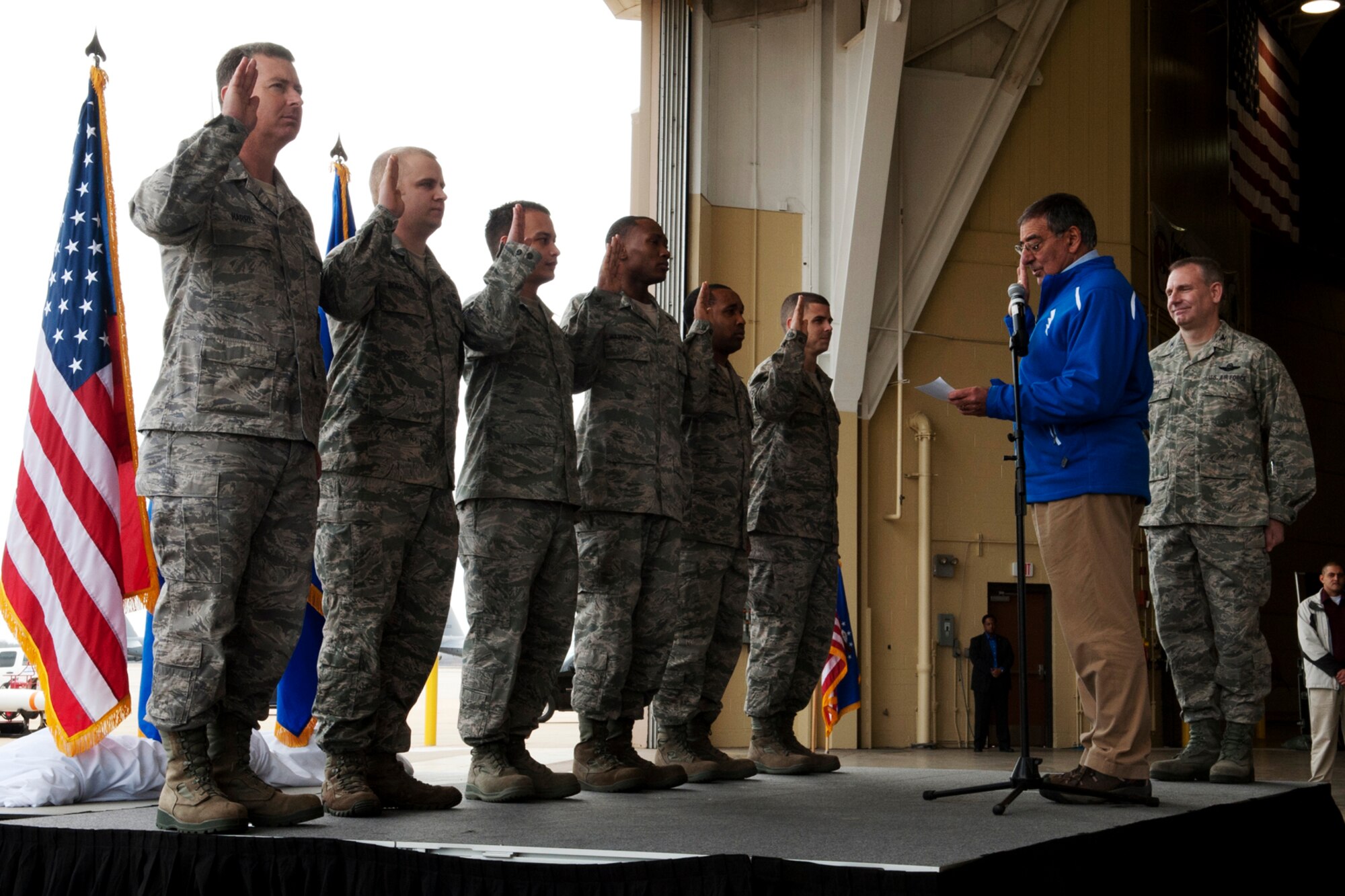 Secretary of Defense Leon E. Panetta reenlists Airmen during an All-Call, Barksdale Air Force Base, La., Feb. 17, 2012. Then Secretary hosted the All-Call with more than 300 Airmen to thank them for their service and dedication to maintaining America's bomber fleet. (U.S. Air Force photo by Master Sgt. Greg Steele/Released)