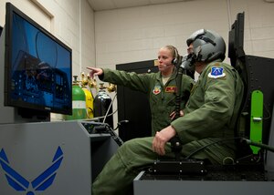 U.S. Air Force Maj. Tom “Vito” Massa (right), 633rd Aerospace Medical Squadron Physiological Flight commander, flies an F-22 Raptor profile on a reduced oxygen breathing device with assistance from 1st Lt. Kimberly Dowd (left), 633rd Aerospace Medical Squadron aerospace physiologist, at the Physiological Training Center at Langley Air Force Base, Va., Feb. 14, 2012.  The ROBD exposes aviators to lower concentrations of oxygen, mimicking atmospheric gaseous concentrations at various altitudes.  (U.S. Air Force photo by Senior Airman John D. Strong II/Released)