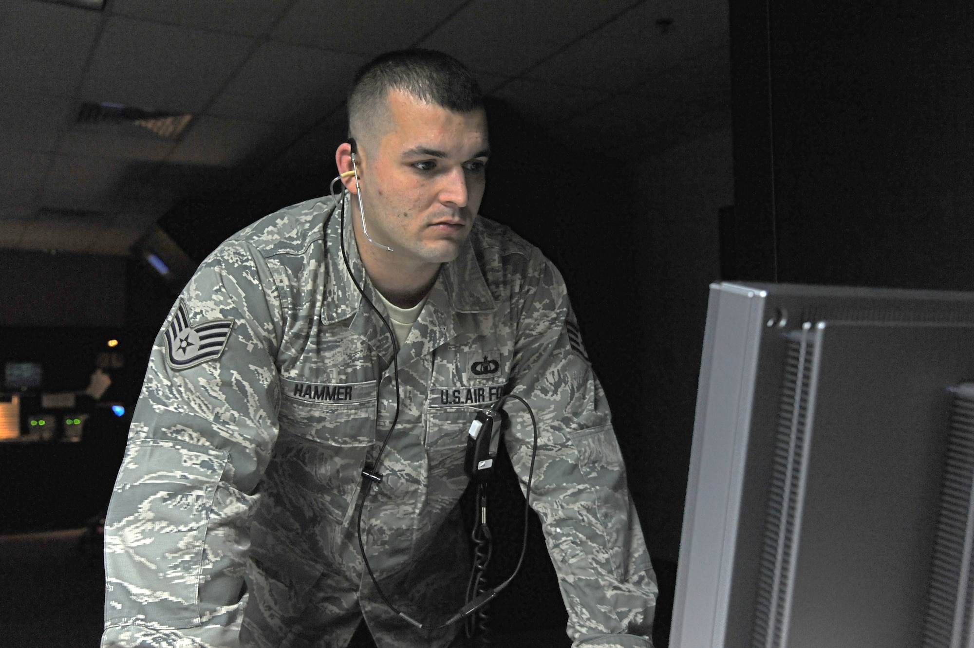 LAUGHLIN AIR FORCE BASE, Texas – Staff Sgt. John Hammer, 47th Operations Support Squadron Radar Approach Control section senior watch supervisor, watches a monitor in the RAPCON here Feb 15. Hammer and the rest of the air traffic control team control the busiest RAPCON in the Air Force controlling a combined 337,436 operations. (U.S. Air Force photo/Airman 1st Class Nathan L. Maysonet)