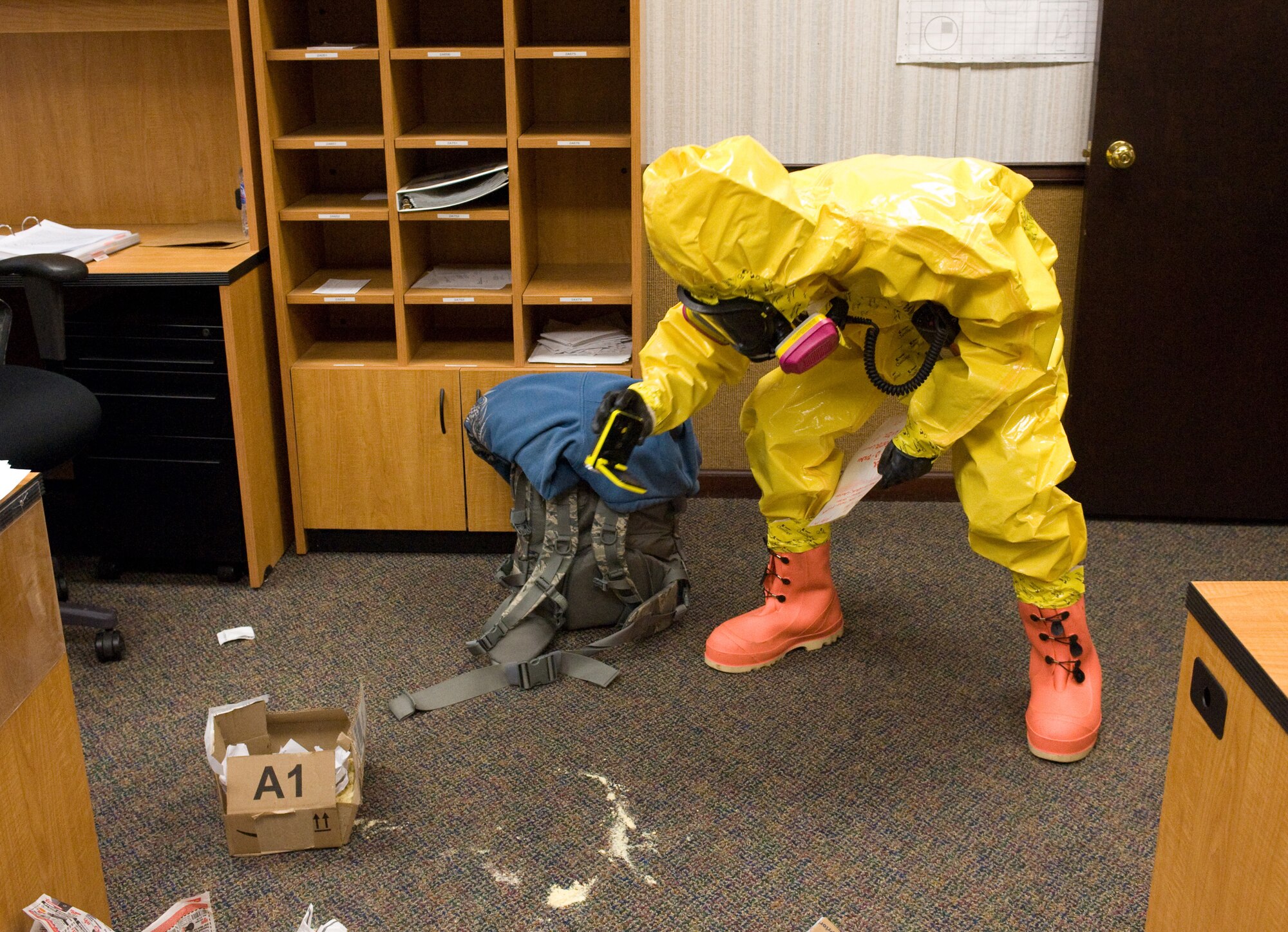 An emergency management technician with the 436th Civil Engineer Squadron, photographs a simulated chemical agent during the Major Accident Response Exercise Feb. 16, 2012, at Dover Air Force Base, Del. The MARE tested the emergency management personnel on proper procedures when handling a suspicious package that contained unknown chemicals. (U.S. Air Force photo by Steve Kotecki)