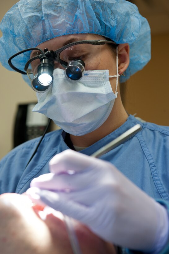 Senior Airman Taylor Johnson, 28th Medical Operations Squadron dental assistant journeyman, inspects teeth during an annual cleaning in the dental clinic at Ellsworth Air Force Base, S.D., Feb. 7, 2012. Carefully inspecting Airmen’s teeth allows Johnson to identify potential problem areas and increases overall excellence in Airmen’s oral health. (U.S. Air Force photo by Airman 1st Class Kate Thornton/Released)