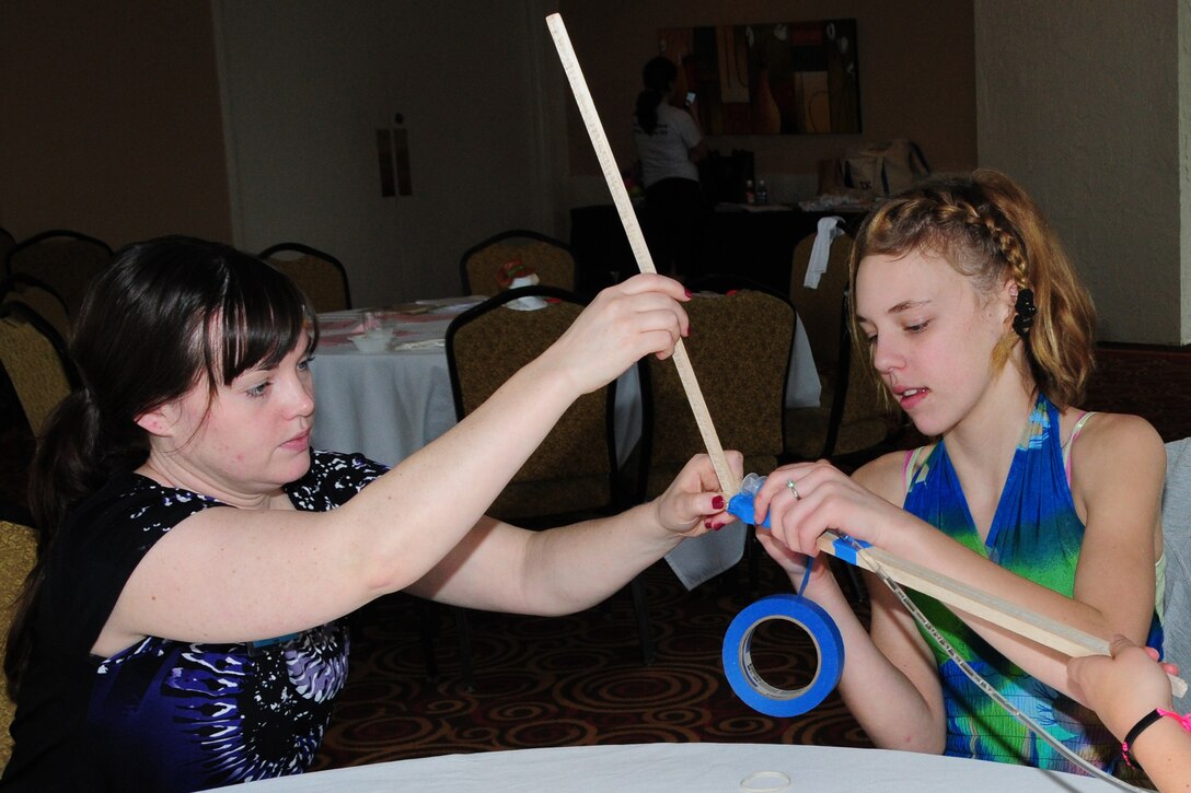 JACKSONVILLE, Fla—U.S. Air Force Reserve Staff Sgt. Marie Anthony, a
medical technician with the 910th Medical Squadron, assits13-year old Lexi
Curry on a group project at the Yellow Ribbon Reintegration Program (YRRP)
held at the Jacksonville Wyndham Hotel Feb. 19. Anthony along with 13 other
Citizen Airmen from the 910th Airlift Wing, volunteered to support the
event.  The YRRP is a DoD-wide effort to promote the well-being of National
Guard and Reserve members, their families and communities, by connecting
them with resources throughout the deployment cycle. Through these events,
service members and loved ones connect with local resources before, during,
and after deployments. For more information about the Yellow Ribbon
Reintegration Program visit www.yellowribbon.mil. 
U.S. Air Force Photo by Master Sgt. Peter Borys
