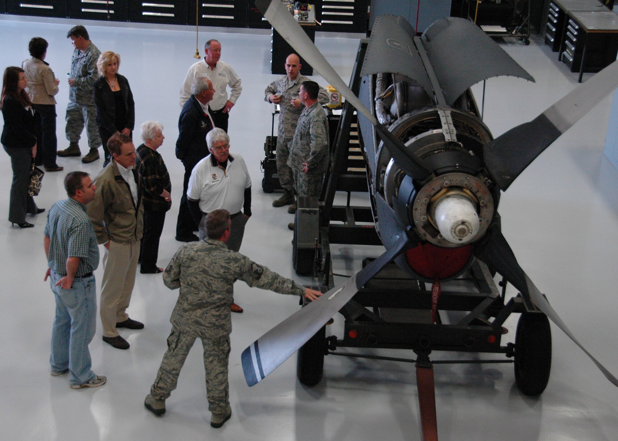 Uniformed reservists inside Duke Field’s 919th Maintenance Squadron Propulsion Flight hangar stand by an MC-130E Combat Talon I engine Feb. 15 as they explain to visiting Eglin AFB and Duke honorary commanders how they conduct their maintenance procedures.  The honorary commanders for dozens of Eglin and Duke Field organizations toured both bases to gain a better understanding of how their Airmen perform their respective missions for national defense.  (U.S. Air Force photo/Dan Neely)