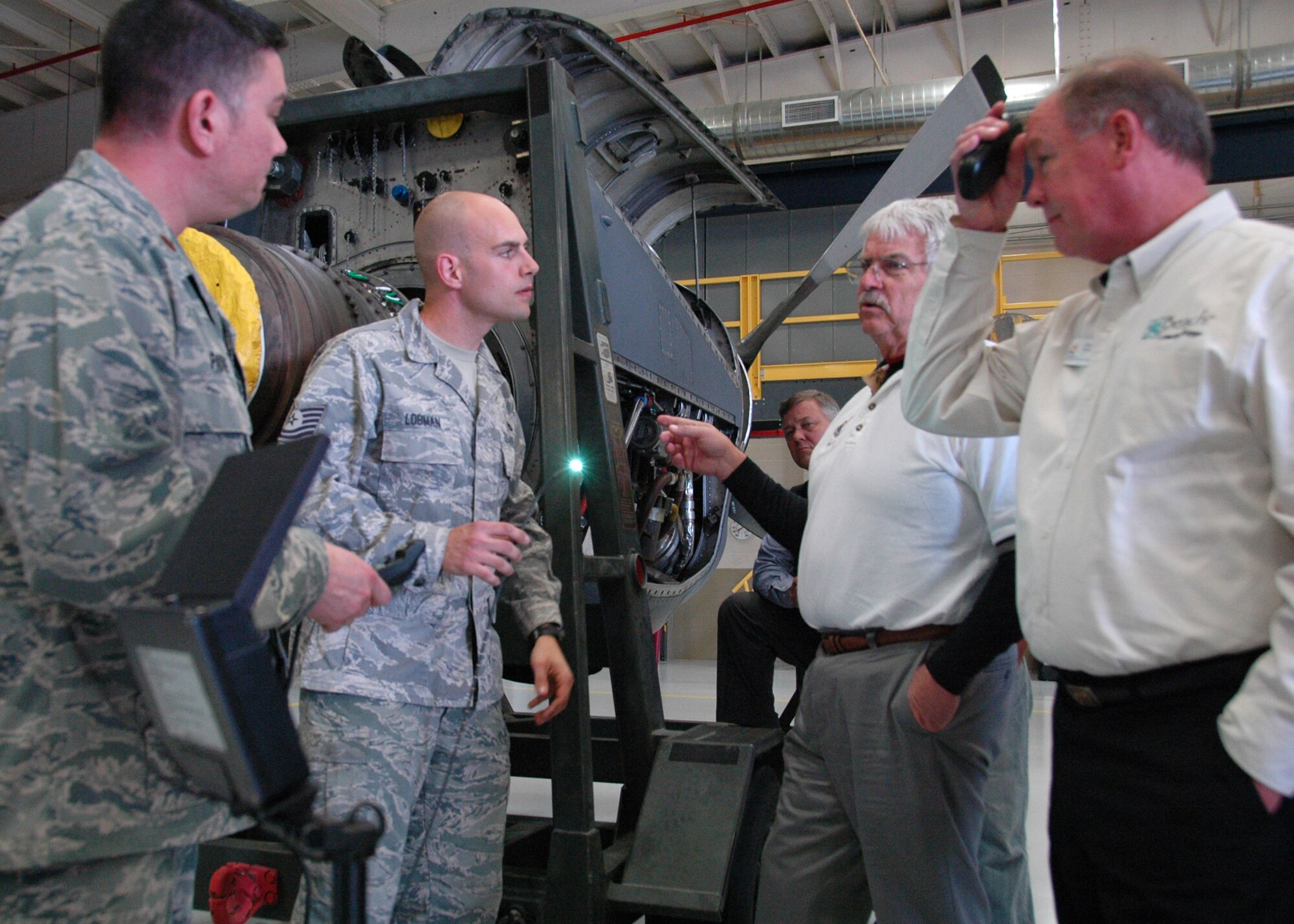 Tech. Sgt. Gregory Lobman from Duke Field’s 919th Maintenance Squadron holds the glowing video camera tip of a bore scope as he tells visiting Eglin AFB and Duke Field honorary commanders Feb. 15 how it’s used in inspecting MC-130 aircraft engines.    The honorary commanders for dozens of Eglin and Duke Field organizations toured both bases to gain a better understanding of how their Airmen perform their respective missions for national defense.  (U.S. Air Force photo/Dan Neely)