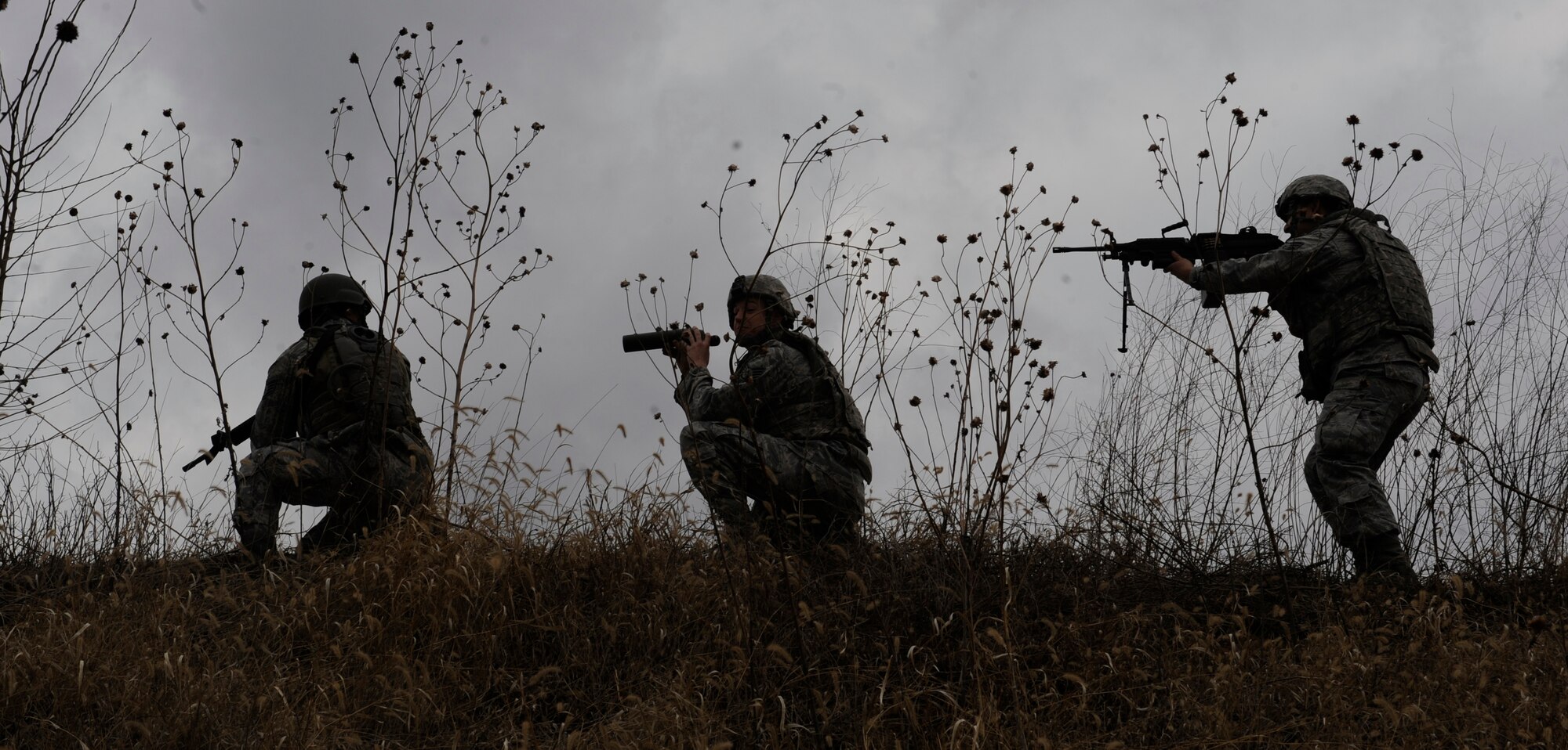 WHITEMAN AIR FORCE BASE, Mo. -- Staff Sgt. Michael Boutte, Staff Sgt. Dustin Stout and Senior Airman Jesus Barraza, 509th Security Forces Squadron combat arms instructors, employs team tactics here Jan. 31. The security forces team works daily to improve tactics, awareness, vigilance and survivability. Training teaches Airmen how to overcome challenges in the mission here and teaches strategies for survivability.  (U.S. Air Force photo by Staff Sgt. Alexandra M. Boutte) (RELEASED)