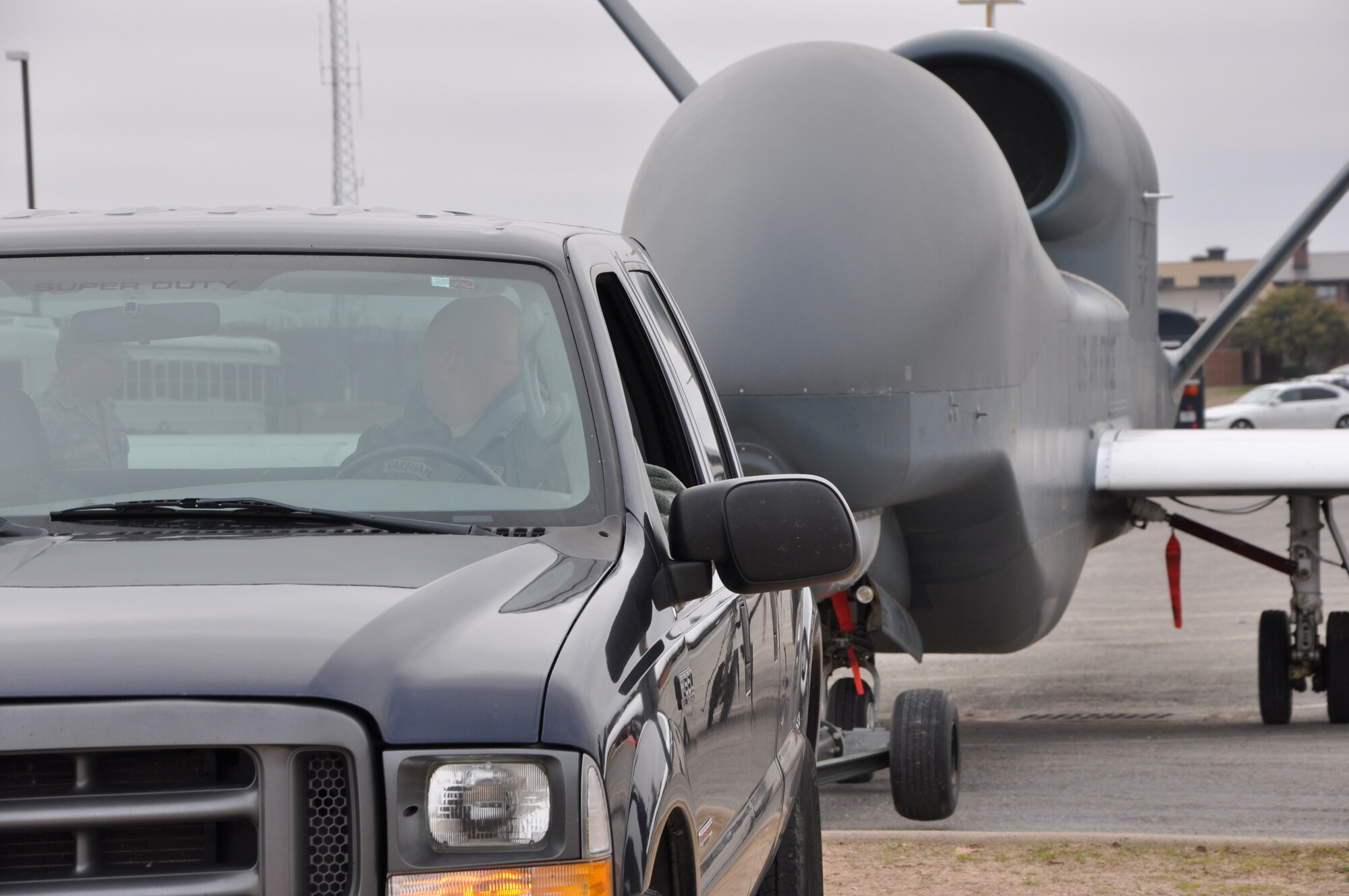 GOODFELLOW AIR FORCE BASE, Texas – Staff Sgt. Mark Wakeham, 76th Aircraft Maintenance Group crew chief, tows the RQ-4 Global Hawk Intelligence, Surveillance and Reconnaissance aircraft into position Feb. 6. The RQ-4 was lifted onto a platform as the base’s newest static display. (U.S. Air Force photo/ Staff Sgt. Tong Duong)