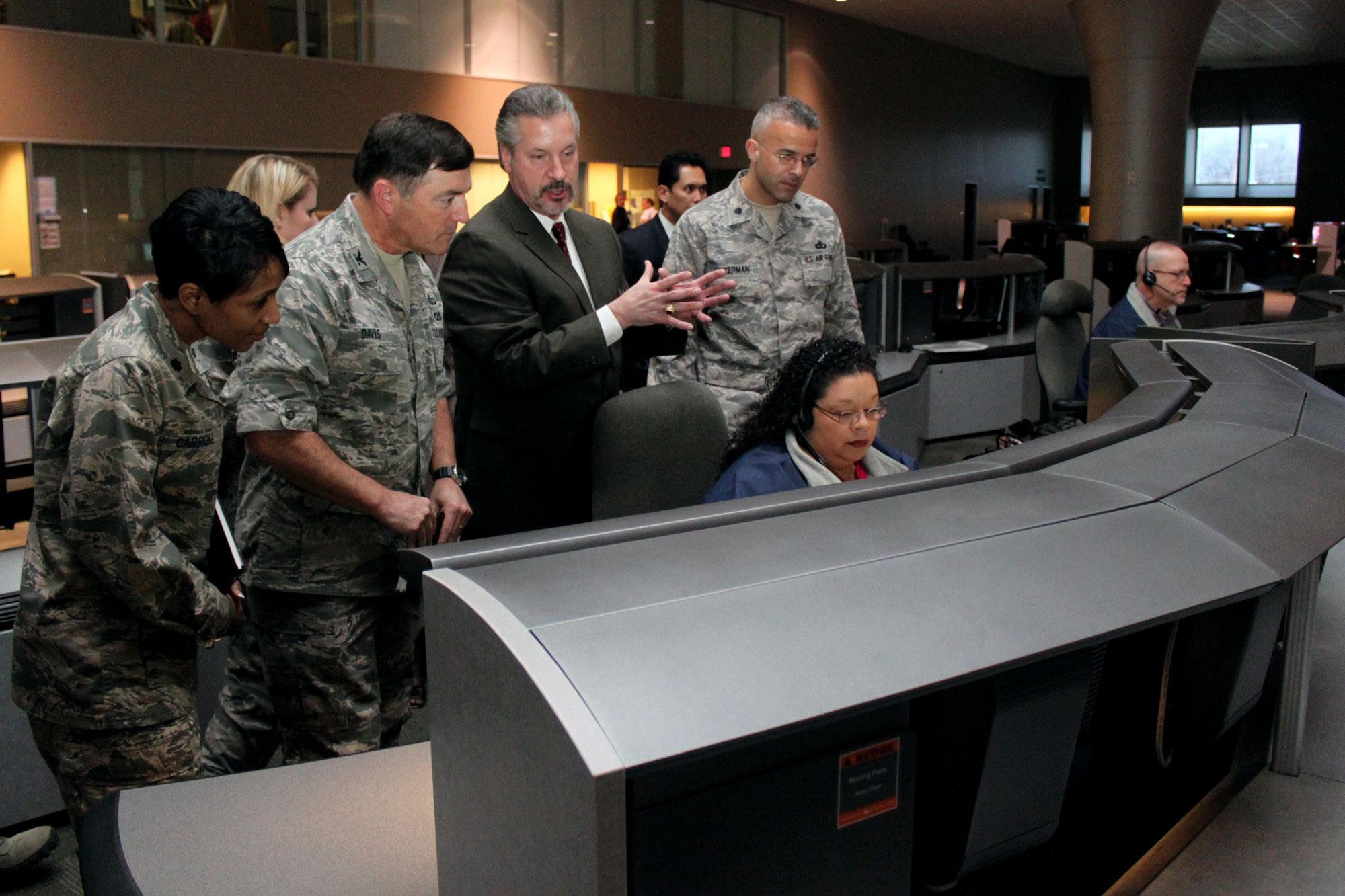 Houston Emergency Center Director David Cutler explains the 9-1-1 call center's operational capabilities to Col. James Davis, Total Force Service Center-San Antonio director, during his team's visit Feb. 10. Air Force Personnel Center officials toured the HEC to learn about the center’s management strategies and operations processes that can be emulated in the TFSC-SA. (Air Force photo/Tech. Sgt. Steve Grever)