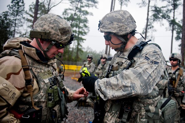 U.S. Air Force Capt. George Hern, 23d Security Forces Squadron flight commander, left, conducts a pre-combat inspection with Airman 1st Class Jordan Patterson, 23d SFS patrolman, during an operational readiness exercise Feb. 16, 2012, at Moody Air Force Base, Ga. The inspection was done prior to a patrol rehearsal and ensured every member had the required equipment to complete the mission. (U.S. Air Force photo by Staff Sgt. Jamal D. Sutter/Released) 