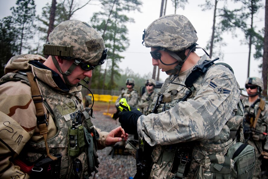 U.S. Air Force Capt. George Hern, 23d Security Forces Squadron flight commander, left, conducts a pre-combat inspection with Airman 1st Class Jordan Patterson, 23d SFS patrolman, during an operational readiness exercise Feb. 16, 2012, at Moody Air Force Base, Ga. The inspection was done prior to a patrol rehearsal and ensured every member had the required equipment to complete the mission. (U.S. Air Force photo by Staff Sgt. Jamal D. Sutter/Released) 