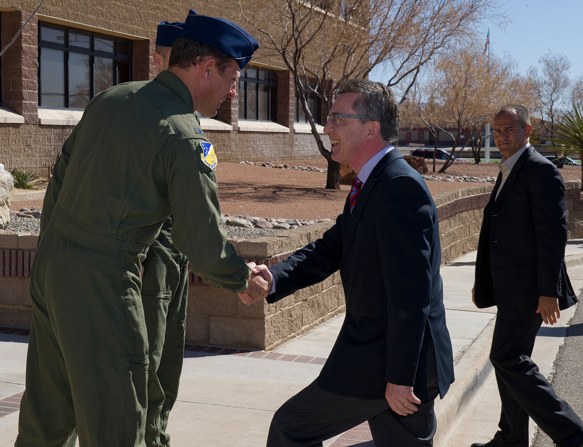 Dr. Thomas de Maiziere, the Germany Federal Minister of Defense, greets U.S. Air Force Col. David Krumm, the 49th Wing commander, at Holloman Air Force Base, N.M., Feb. 15, 2012. The German Air Force has conducted flying operations at Holloman AFB since 1992. (U.S. Air Force photo/Senior Airman DeAndre Curtiss)