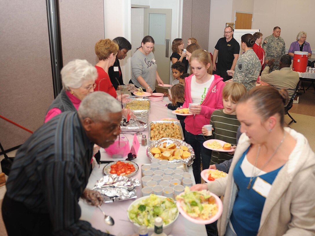 Fort Eustis Military and Family Life Consultant Program volunteers serve military spouses and families assorted desserts during the Dinner for Families of Deployed event at the Fort Eustis Regimental Chapel Feb 14. The Fort Eustis Regimental Chapel community lends their support every second Tuesday of the month by sponsoring a free dinner for families and spouses of deployed servicemembers. (U.S. Air Force photo by Staff Sgt. Antoinette Gibson/Released)