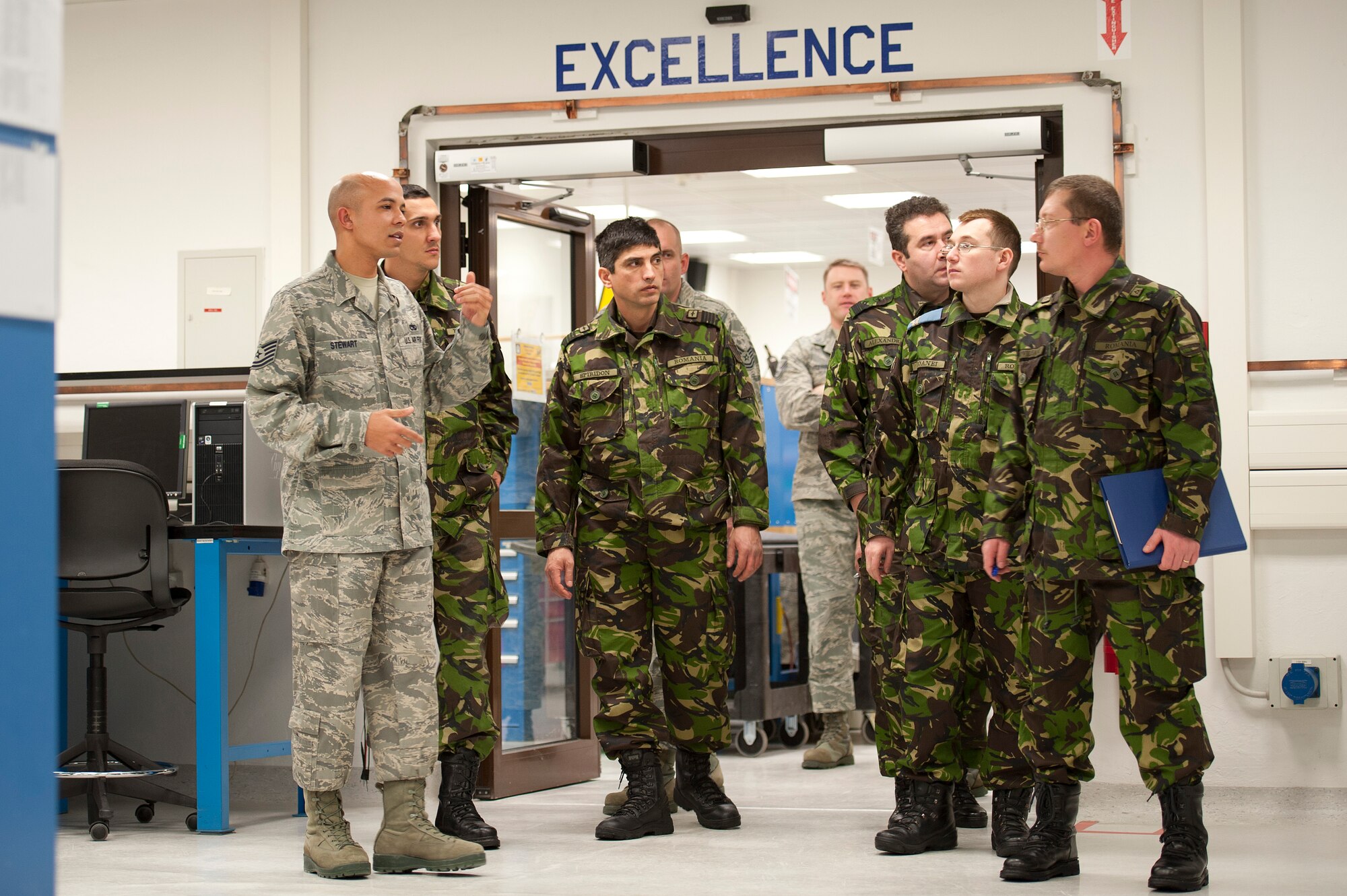 U.S. Air Force Tech. Sgt. Kevin Stewart, 86th Maintenance Squadron test measurement diagnostic equipment technician, speaks to Romanian Air Force members during a familiarization tour of the Precision Measurement Equipment Laboratory on Ramstein Air Base, Feb. 9, 2012. (U.S. Air Force photo by Senior Airman Stephen J. Otero)