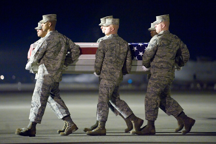 A U.S. Air Force carry team transfers the remains of Air Force Senior Airman Julian S. Scholten of Upper Marlboro, Md., at Dover Air Force Base, Del., Feb. 21, 2012. Scholten was assigned to the 25th Intelligence Squadron, Hurlburt Field, Fla. (U.S. Air Force photo/Adrian R. Rowan)