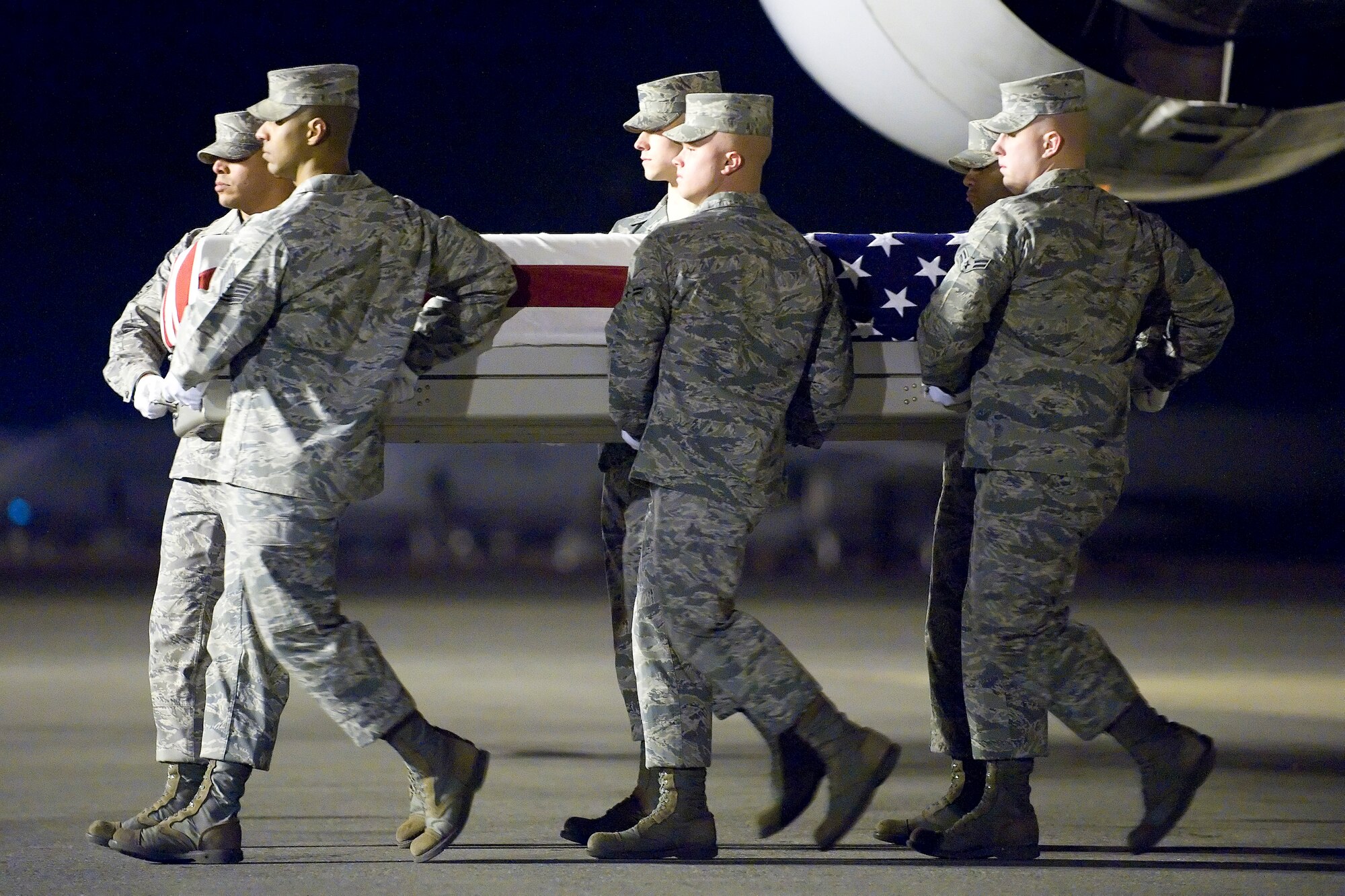 A U.S. Air Force carry team transfers the remains of Air Force 1st Lt. Justin J. Wilkens of Bend, Ore., at Dover Air Force Base, Del., Feb. 21, 2012. Wilkens was assigned to the 34th Special Operations Squadron, Hurlburt Field, Fla. (U.S. Air Force photo/Adrian R. Rowan)
