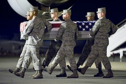A U.S. Air Force carry team transfers the remains of Air Force Capt. Ryan P. Hall of Colorado Springs, Colo., at Dover Air Force Base, Del., Feb. 21, 2012. Hall was assigned to the 319th Special Operations Squadron, Hurlburt Field, Fla. (U.S. Air Force photo/Adrian R. Rowan)
