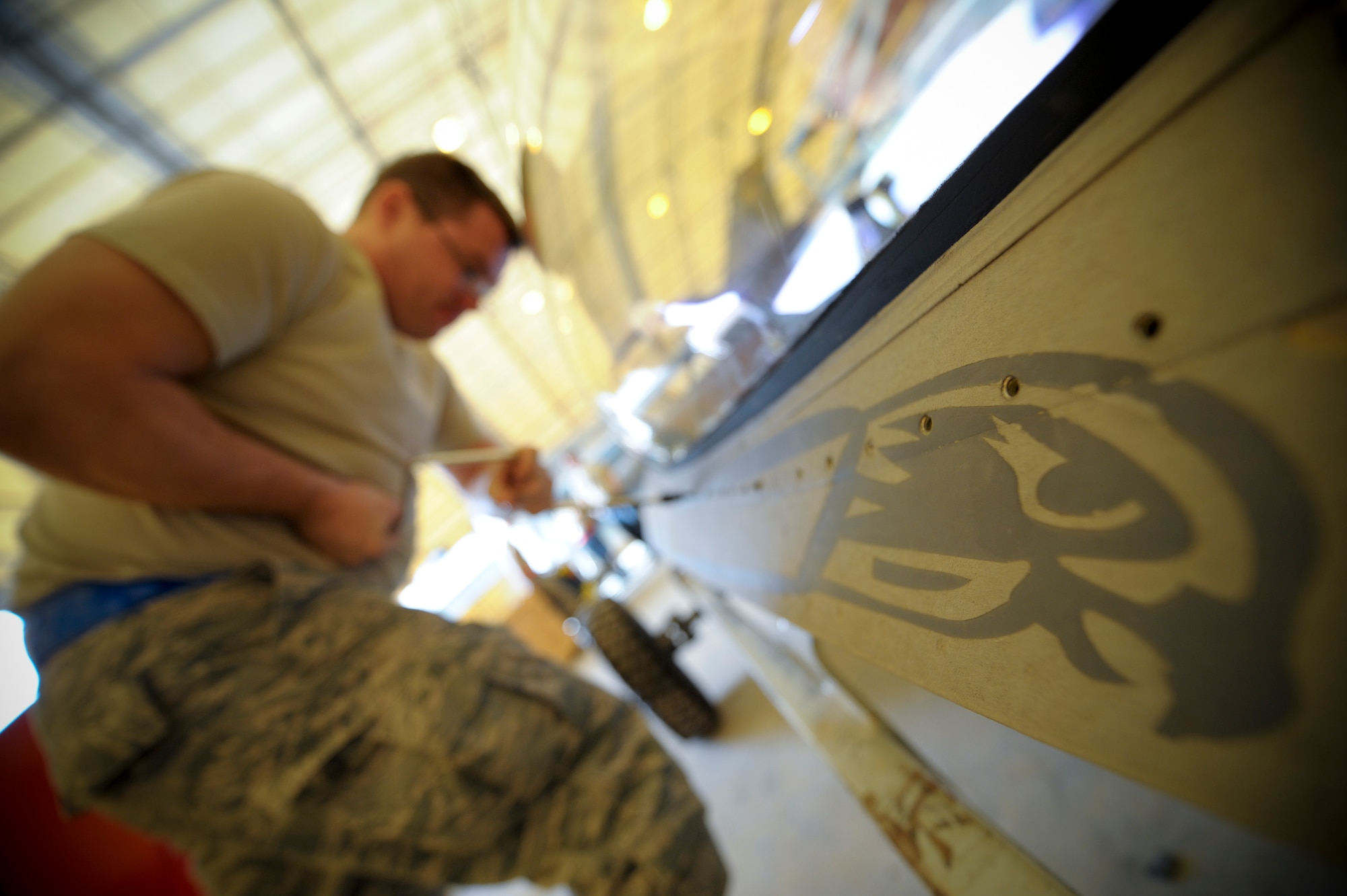 Staff Sgt. John Self, 332nd Expeditionary Maintenance Squadron egress member, attaches a panel after replacing an F-16 Fighting Falcon canopy at an undisclosed location in Southwest Asia, Feb. 19, 2012. Self is deployed from Shaw Air Force Base, S.C. and is a native of Atlanta, Texas. (U.S. Air Force photo by Staff Sgt. Joshua J. Garcia/Released)