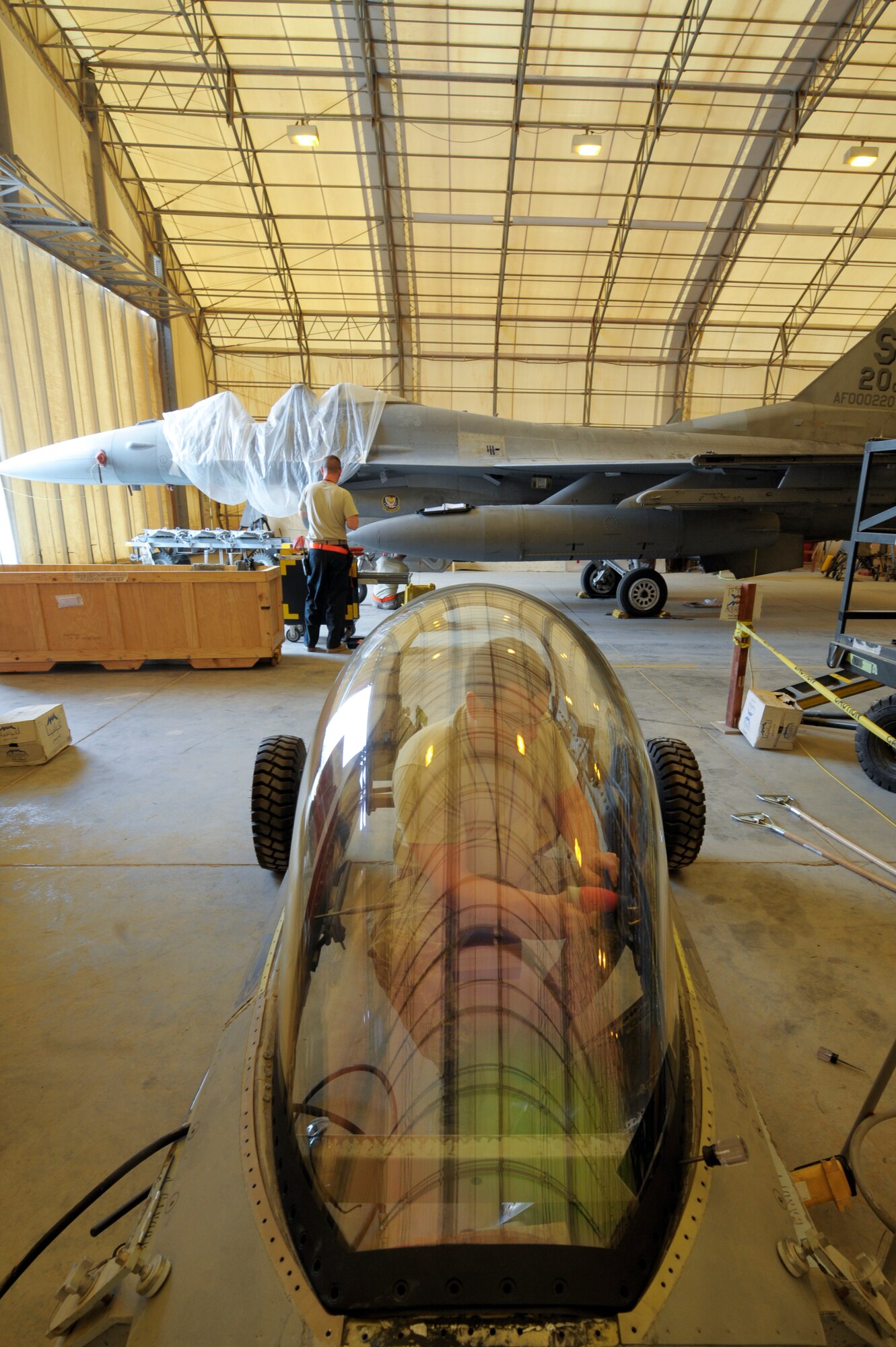 Staff Sgt. John Self, 332nd Expeditionary Maintenance Squadron egress member, works on a canopy for an F-16 Fighting Falcon at an undisclosed location in Southwest Asia, Feb. 19, 2012. The canopy consists of a transparency that is sealed to the aircraft’s canopy frame. Self is deployed from Shaw Air Force Base, S.C., and is a native of Atlanta, Texas. (U.S. Air Force photo by Staff Sgt. Joshua J. Garcia/Released)