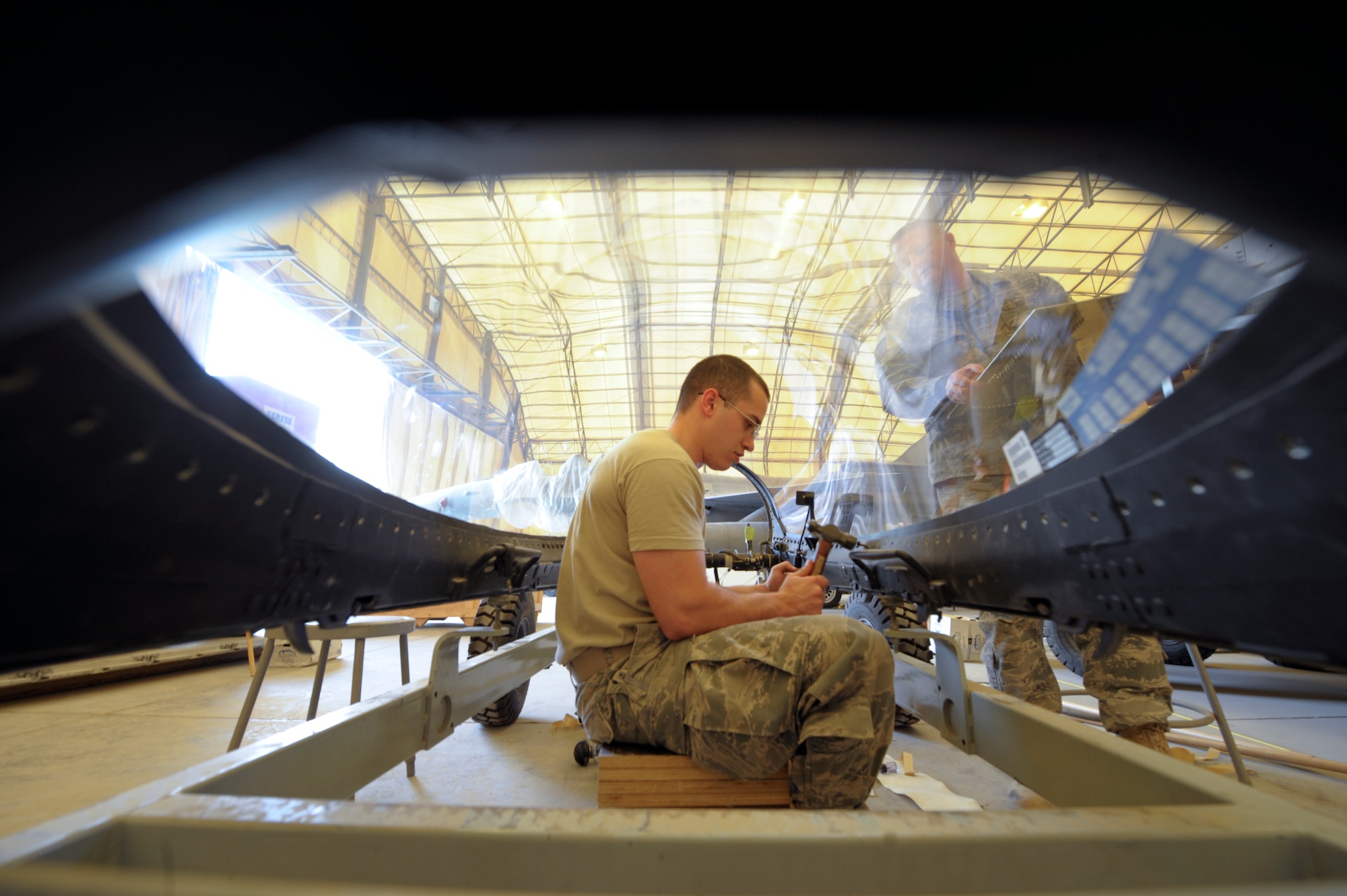 Senior Airman Tony Kendall, 332nd Expeditionary Maintenance Squadron egress member, lines up placement holes from the transparency to the canopy frame at an undisclosed location in Southwest Asia, Feb. 19, 2012. Properly aligned placement holes ensure that the canopy will be able to keep a complete seal on an F-16 Fighting Falcon. Kendall is deployed from Shaw Air Force Base, S.C., and is a native of Miami, Fla. (U.S. Air Force photo by Staff Sgt. Joshua J. Garcia/Released)