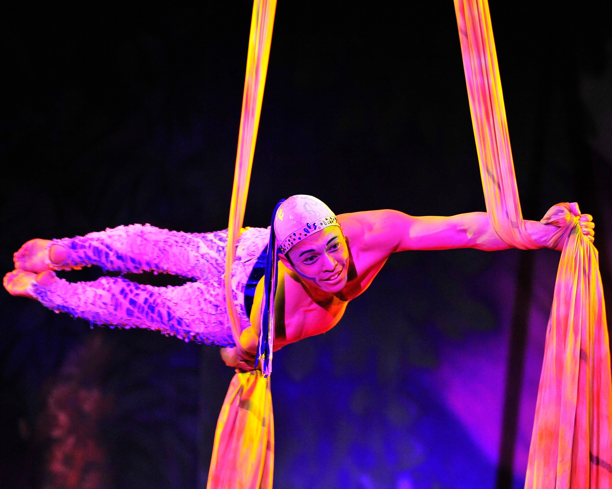 Members of Team Ramstein waited an hour in the cold for a warm seat to view Cirque Dreams "Jungle Fantasy” World Tour performance at Ramstein Air Base, Germany, Feb. 17, 2012.  The hour and a half show featured vibrant costumes, amazing acts of physical strength and skill, aerial acts, tumblers, jugglers, gymnasts, contortionists and jokesters. Cirque Dreams partnered with Armed Forces Entertainment to perform "Jungle Fantasy" at 17 military installations in 10 different countries through Asia and Europe.  (U.S. Air Force Photo by/ Staff Sgt. Daylena Gonzalez)