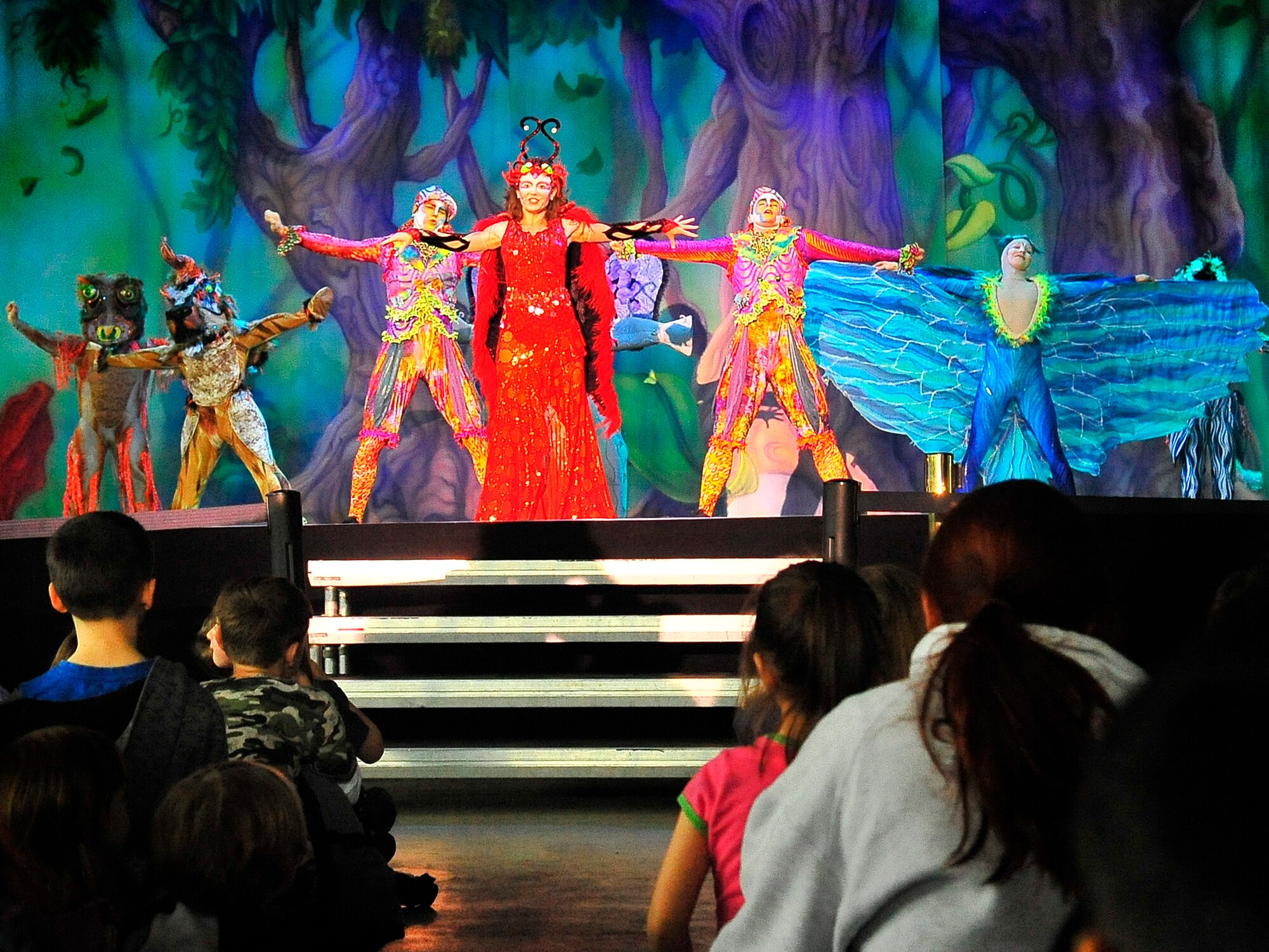 Members of Team Ramstein waited an hour in the cold for a warm seat to view Cirque Dreams "Jungle Fantasy” World Tour performance at Ramstein Air Base, Germany, Feb. 17, 2012.  The hour and a half show featured vibrant costumes, amazing acts of physical strength and skill, aerial acts, tumblers, jugglers, gymnasts, contortionists and jokesters. Cirque Dreams partnered with Armed Forces Entertainment to perform "Jungle Fantasy" at 17 military installations in 10 different countries through Asia and Europe.  (U.S. Air Force Photo by/ Staff Sgt. Daylena Gonzalez)
