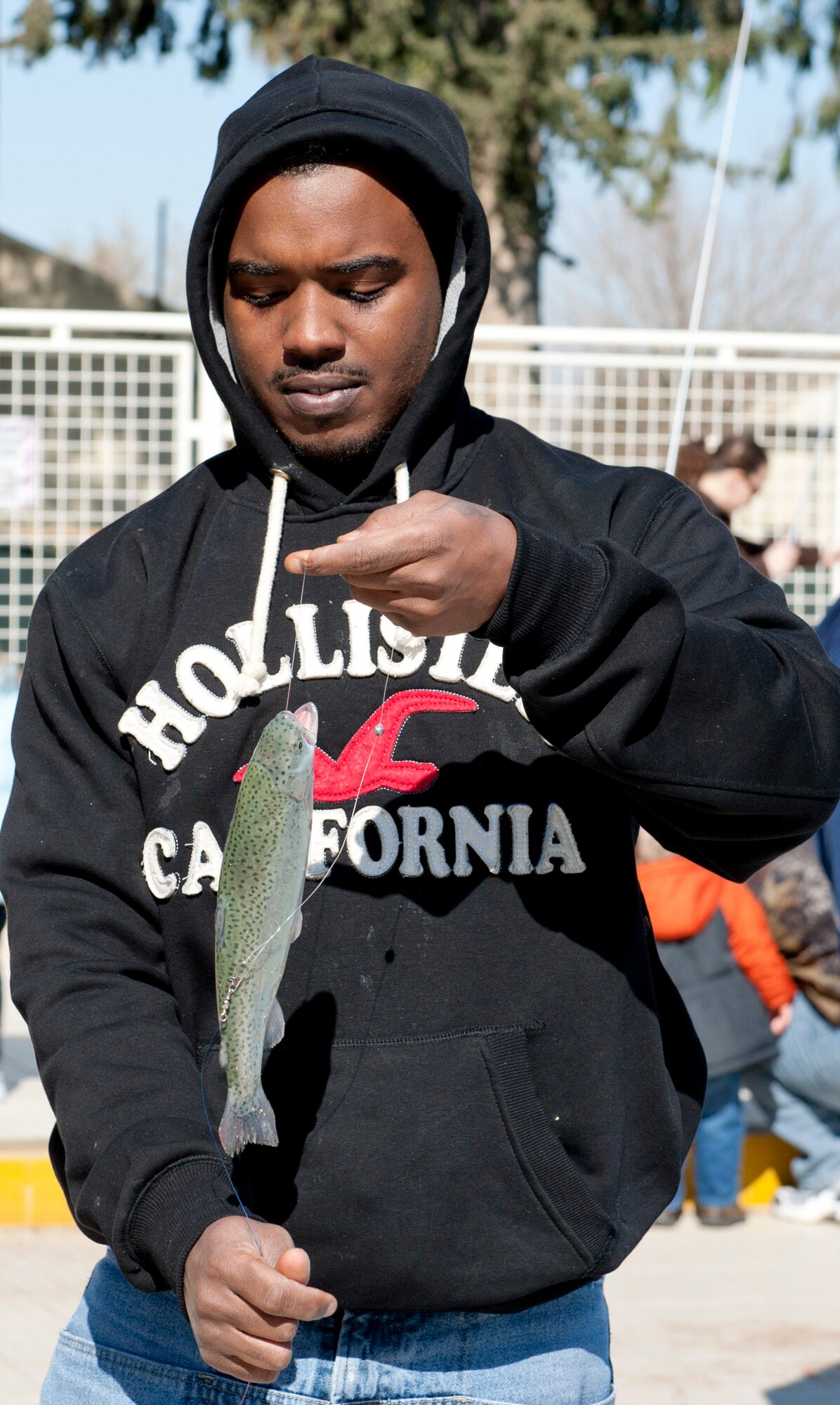 Ramon Holmes, husband of Airman 1st Class Shannon Holmes of the 39th Security Forces Squadron, holds a fish caught during the outdoor-recreation-center sponsored fishing rodeo at the base pool Feb. 19, 2012, at Incirlik Air Base, Turkey. The rodeo began Feb. 18 with 500 fish. More than 300 people participated during the three-day event. (U.S. Air Force photo by Senior Airman Anthony Sanchelli/Released)

