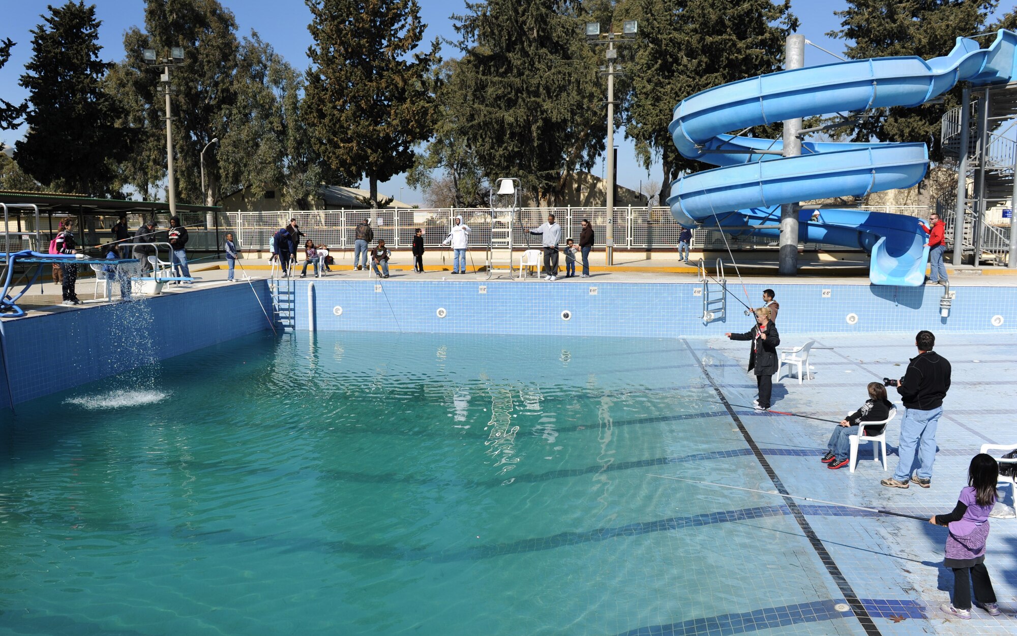 Airmen and their families fish during the fishing rodeo sponsored by the outdoor recreation center at the base pool Feb. 19, 2012, at Incirlik Air Base, Turkey. The rodeo began Feb. 18 with 500 fish. More than 300 people participated during the three-day event. (U.S. Air Force photo by Senior Airman Anthony Sanchelli/Released)
